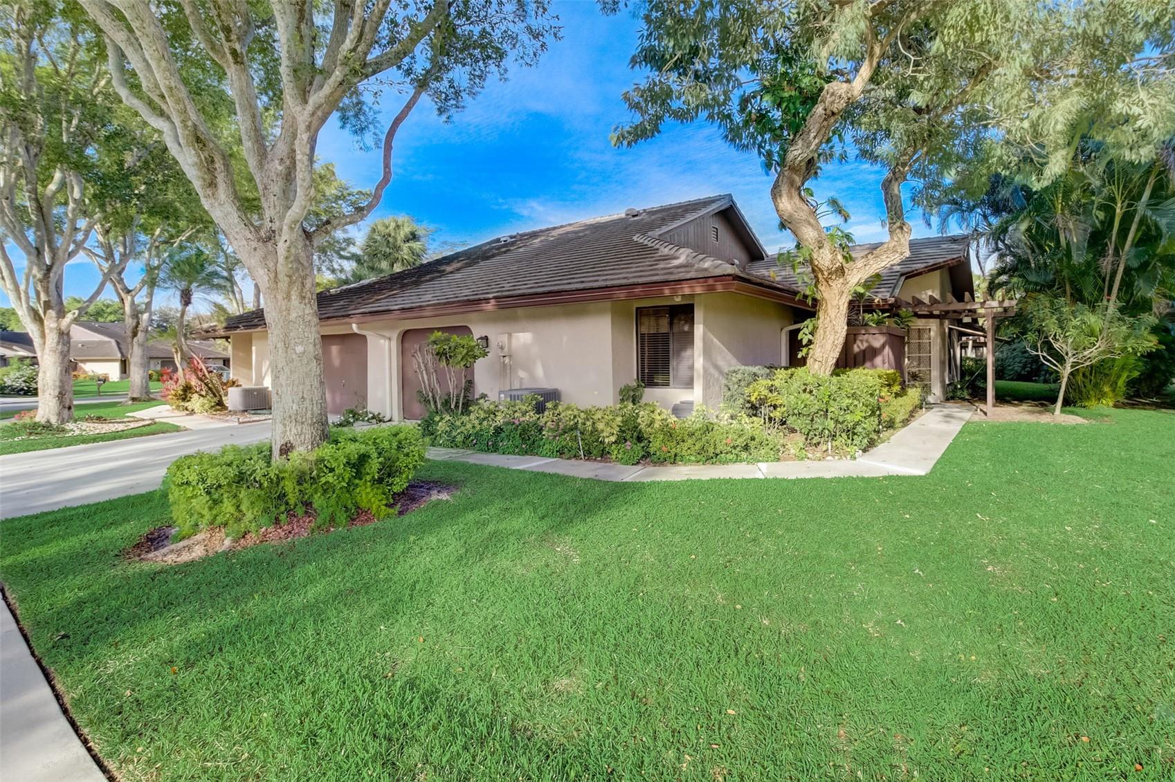 Spacious 3-Bed, 2-Bath Villa in Sought-After Banyan Springs 55+ Community. Secure your slice of paradise with this 3-bed, 2-bath villa that combines style, comfort, and practicality, perfect for relaxed Florida living. Featuring a newer roof (2021), updated A/C, and filled with natural light, this home blends comfort and style. Enjoy hardwood floors, vaulted ceilings, and a glass-enclosed sunroom with peaceful backyard views. An attached garage and ample closet space offer everyday convenience. Set in a pet-friendly, park-like setting, this villa provides a tranquil retreat with resort-style amenities. Live just minutes from shopping, dining, and entertainment in one of the area's most sought-after communities.