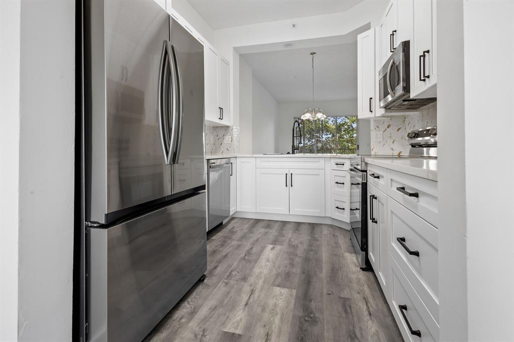 NO EXPENSE SPARED!! DISCOVER THE BEAUTY OF THIS 4TH FLOOR NEWLY FULLY RENOVATED 2-BED, 2-BATH PENTHOUSE MODEL WITH 10 FT CEILINGS! THE UPDATED BATHROOMS SHOWCASE CARRARA ITALIAN PORCELAIN THROUGHOUT AND THIS STUNNING UNIT BOASTS LAKE VIEWS AND ABUNDANT NATURAL LIGHT, OFFERING A PERFECT BLEND OF LUXURY AND STYLE. THE CHEF’S KITCHEN IS BEAUTIFULLY UPGRADED WITH HIGH-END, SLEEK QUARTZ COUNTERTOPS, 42" CABINETRY, AND PREMIUM STAINLESS-STEEL APPLIANCES. THE SPACIOUS PRIMARY SUITE FEATURES A LARGE WALK-IN CLOSET AND A SPA-INSPIRED EN-SUITE BATHROOM. SCREENED-IN BALCONY HAS SERENE WATER VIEWS. IT'S IN THE PRESTIGIOUS 55+ GATED COMMUNITY WITH RESORT-STYLE AMENITIES, INCLUDING A CLUBHOUSE, HEATED POOL, FITNESS CENTER, AND TENNIS COURTS. THERE IS NOTHING ELSE LIKE THIS FOR SALE IN KING'S POINT!