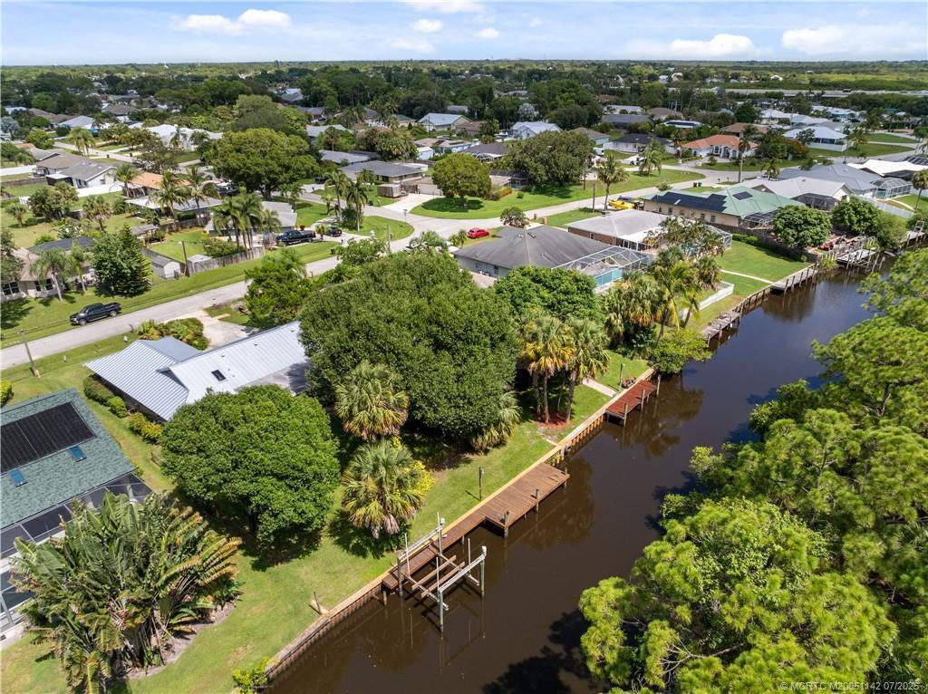OCEAN ACCESS WATERFRONT HOME - BOATER'S PARADISE - FISHING DOCK with 12K BOAT LIFT plus CONCRETE Cap on Sheet Pile SEAWALL. The Property backs up to BEAUTIFUL NATURE PRESERVE --- come home to see Manatees, Sea Otters, and Osprey at your peaceful serene haven that has CBS CONSTRUCTION 3/2/2, Desirable SPLIT FLOOR PLAN, CHERRY CABINETS, LARGE SCREEENED LANAI, and a NEW PREMIUM STANDING SEAM METAL ROOF. GREAT NEIGHBORHOOD (No HOA or Dues) for Walkers, Bicycle, and Dog friendly Park close by. LOCATION - SHORT RIDE TO OCEAN BEACHES, RESTAURANTS, SHOPPING, ... Room for a Pool too! $15,000.00 BUYER CLOSING CREDIT