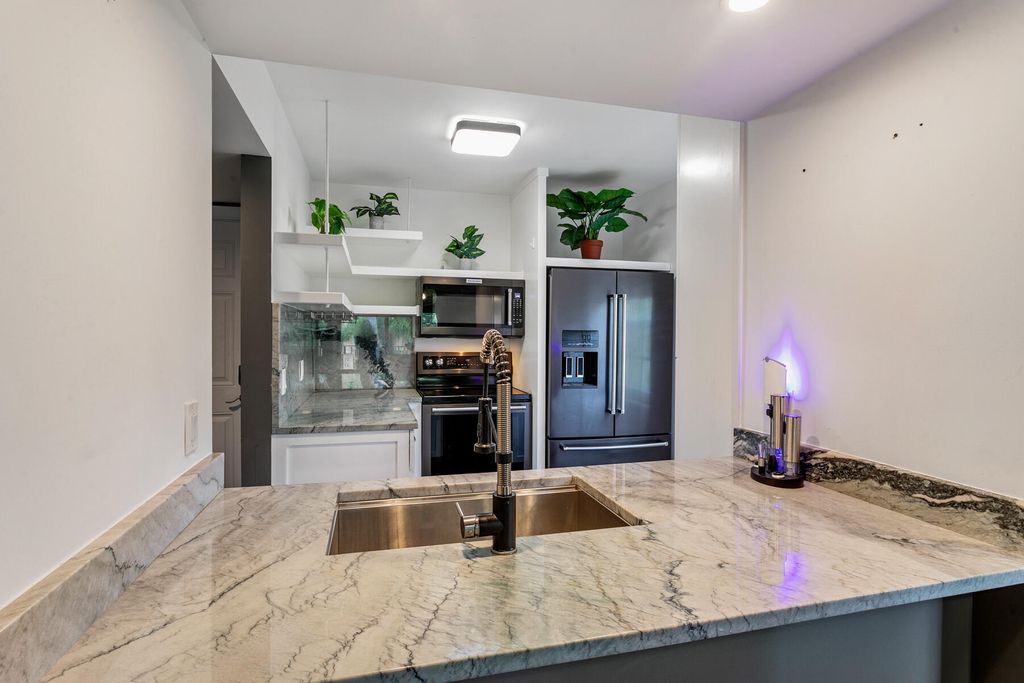 Photo of 1025 Lake Shore Drive #204, Lake Park, FL 33403 (MLS # R11011904)