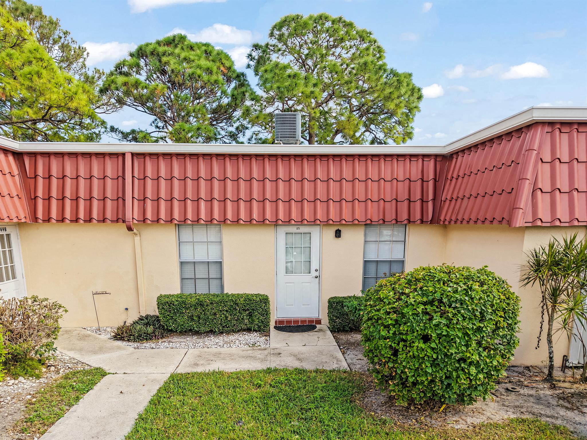 This fully remodeled villa presents a stunning kitchen and bathroom featuring premium wood cabinets, granite countertops, and upgraded white appliances. Elegant vinyl plank flooring runs throughout, accented by fresh baseboards, knock-down ceilings, and tasteful crown molding. Enhancements include a new hot water heater, upgraded bathroom vanity, shower, and toilet, along with a modern electrical panel, plumbing, exterior door, and ceiling fans. The enclosed porch has been opened to expand living space, and interiors showcase fresh paint and designer finishes throughout.