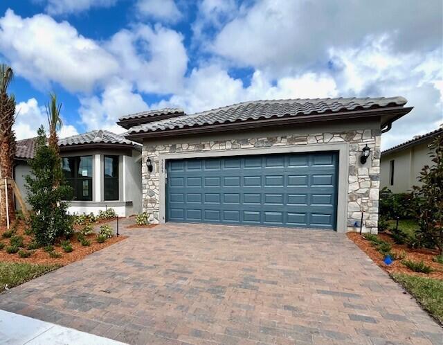 NEW CONSTRUCTION: This Mystique 3 Bedroom plus flex room is everything you've been looking for. The wood-look tile floors exude contemporary charm throughout. The gourmet kitchen boasts fresh white cabinets and Silestone countertops seamlessly blending style and functionality. The gracious and bright owner's suite has an extended walk-in shower. Extend your space with the Screened In Covered Lanai overlooking the lake, creating a haven of comfort and entertainment. Enjoy being just a quick walk away from the Resort Style Amenity campus.