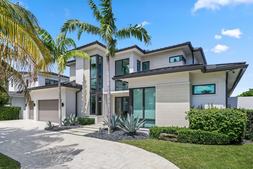 Welcome to your private waterfront oasis in the heart of Delray Beach. Built in 2020 and designed by the late, world-renowned architect Richard Jones, this extraordinary estate offers a seamless blend of modern design, soaring ceilings, and refined coastal living.From the moment you enter, the grand glass staircase and dramatic entryway set the tone for what awaits inside. The home features six spacious bedrooms, six and a half bathrooms, and over 4,500 square feet of carefully crafted living space. Walls of glass invite natural light throughout, while open living and dining areas create the perfect environment for both everyday living and large-scale entertaining.The gourmet chef's kitchen is outfitted with premium finishes and professional-grade appliances, serving as the heart