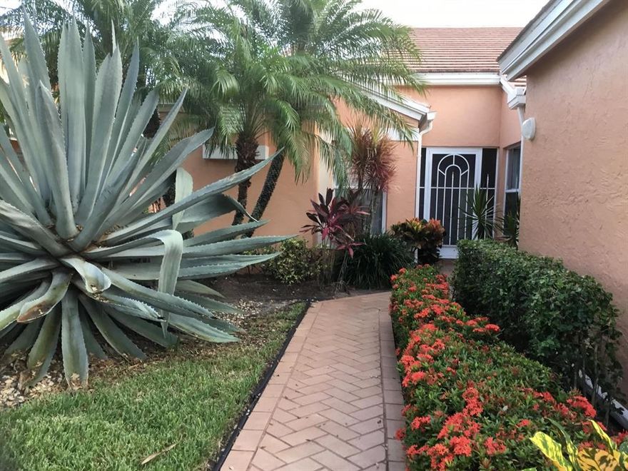 Rarely available Coral Lakes Patio home; This fabulous semi attached 2 bedroom, 2 bath plus den and one car garage  villa is spacious, light and bright; features a new air conditioner and roof; 2 skylights, high ceilings, upgraded floors, upgraded eat-in kitchen, a bird cage lanai overlooking a long garden view; A wonderful home in popular community of Coral Lakes. This 55 plus community has a most gorgeous clubhouse, hotel like pool, café which offers much more than just breakfast and lunch; shows, activities and lectures that are way above all the rest.  Available for immediate occupancy furniiture may be included