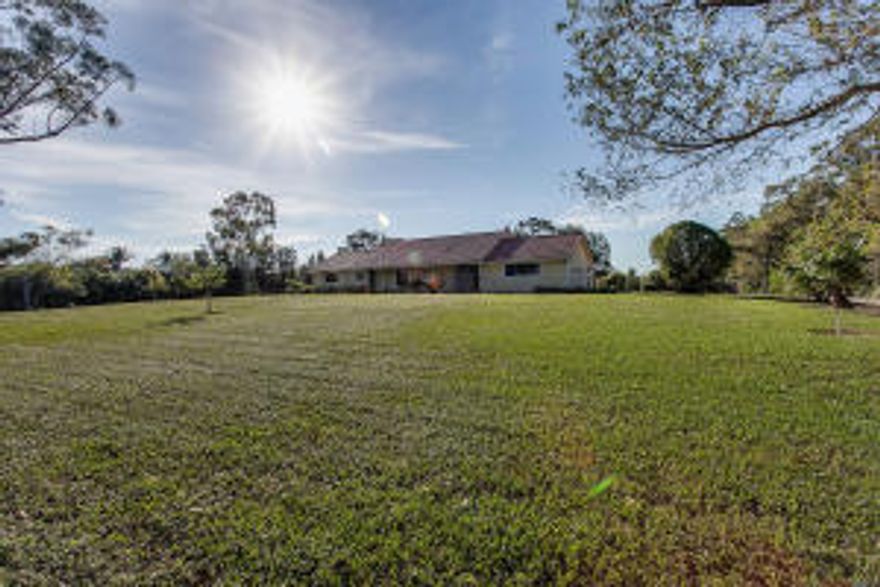 A little slice of heaven right in the heart of Wellington. Enter through the tree lined drive to a blissful living with the feeling of an artist retreat located on 5 of the most beautiful acres in Wellington. Mature trees and pond give you the sensation that you have not left the northeast while enjoying the warmth of Florida winters. Enjoy renting this pool property for the season, close to the WEF and GLOBAL show grounds and the polo grounds. A perfect spot to set up for the winter, this property is high, dry and ready for a tent and paddocks for you and your horses serene getaway from the show. Additional stabling available to rent at surrounding properties.