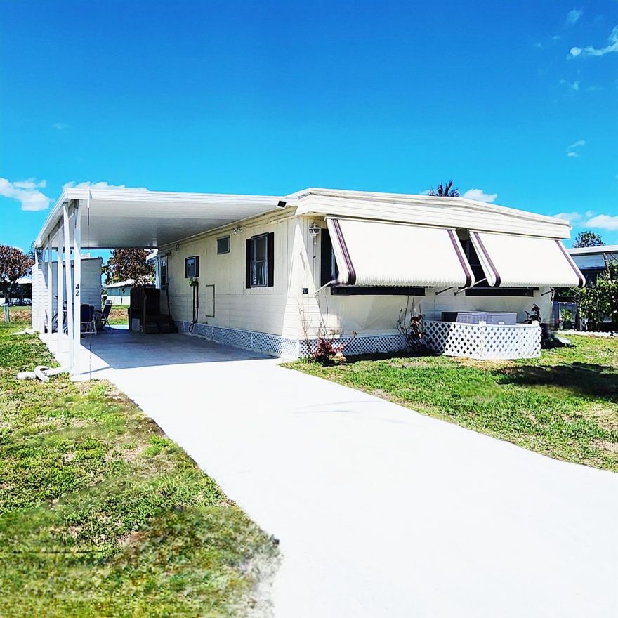 A Must See! Beautiful Water Views w/ this charming 2bed/1 & .5 bathroom. Roof & AC 2024 and 2022 Flooring. Step inside & the beauty continues w/ a spacious kitchen, ample cabinetry, 2025 SS appliances. Complete set of Storm shutters included! The master bed boasts en-suite half bath; while the spare bedroom is ideal for guests or home office. Relax & enjoy the views in the enclosed Florida room. A covered carport and storage shed adds extra convenience. Large sized offers space great for pets, gardening, grilling & more! PRIME LOCATION;near beach, grocery, postal, banks, hospital, pharmacy & more! Lot Lease 892.53 incl. trash, lawn, private free golf, heated pool, fitness, pickleball/tennis, shuffleboard,bocce, gym, library, cards,MahJong, workshop, parades, dinners, dances, trips & more!