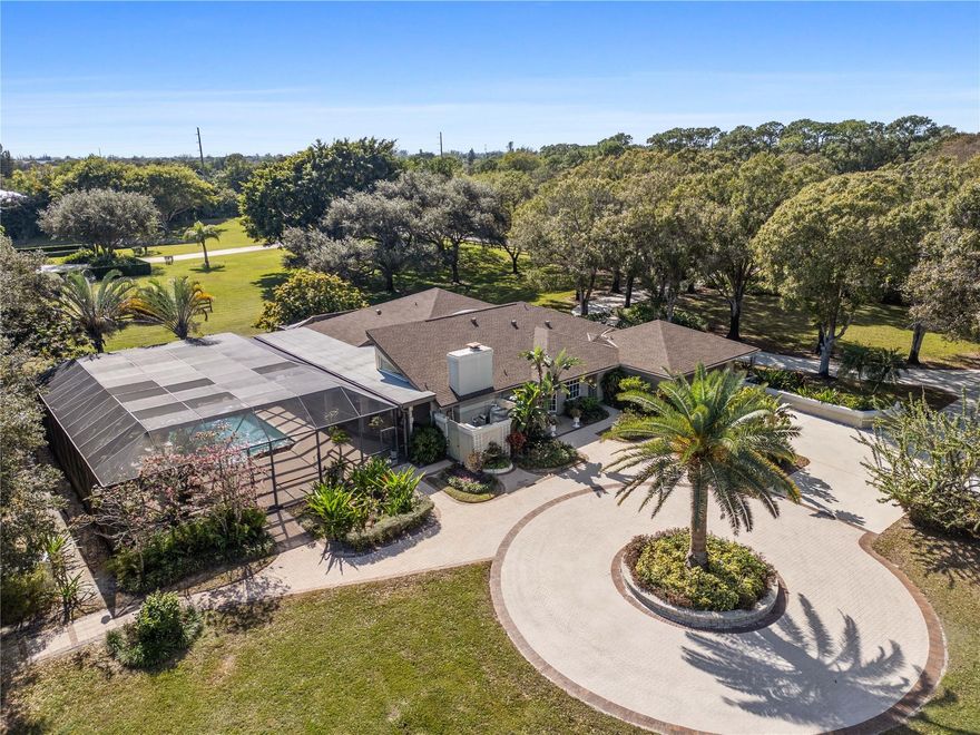 Nestled on over 5 lush acres, this private estate offers luxury and tranquility behind a double-gated entrance. The 3-bedroom, 3-bathroom residence features elegant marble floors, a cozy wood burning fireplace, and all impact windows for peace of mind. A 6-car garage provides ample space for vehicles and storage. NEW ROOF(2023) in main house. FULL HOUSE GENERATOR. Outdoors, enjoy a resort-style pool with spa, summer kitchen, and a serene gazebo. Stay active with a tennis court, exercise station, and scenic track. The grounds are dotted with mature fruit trees, blending beauty with bounty. This property is a rare blend of sophistication, privacy, and lifestyle—perfect for those who crave space without sacrificing comfort.