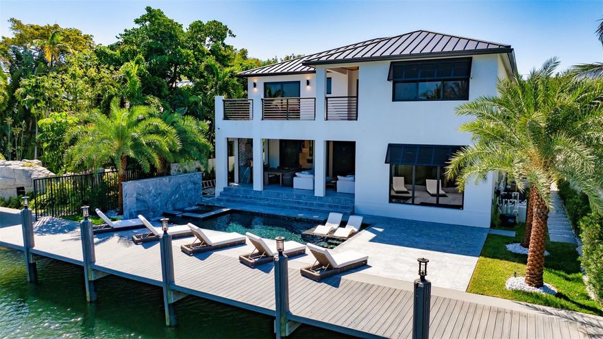 Turn-Key RH Styled & Furnished New Construction Estate sited on 65' of deepwater in Rio Vista. This 5 bed/5.5 bath gated residence has 5,122 total sqft of seamless indoor-outdoor living. Chefs kitchen fit with 6 burner Viking gas stove/griddle, Viking double refrigerator/freezer, 2 Viking dishwashers, Bosch built-in coffee/espresso maker, European cabinetry, & 24" Thermador wine column & ice maker. Smart-house tech: electronic shades, double-sided linear electric fireplace, & programmable hot steam shower! Enhanced closet design and expansive covered summer kitchen & loggia complete with gas grill, refrigeration, & impressive electric phantom screens. A heated salt-water pool/spa with cascading waterfall features, set within marble decking, leads to the new composite dock & raised seawall.