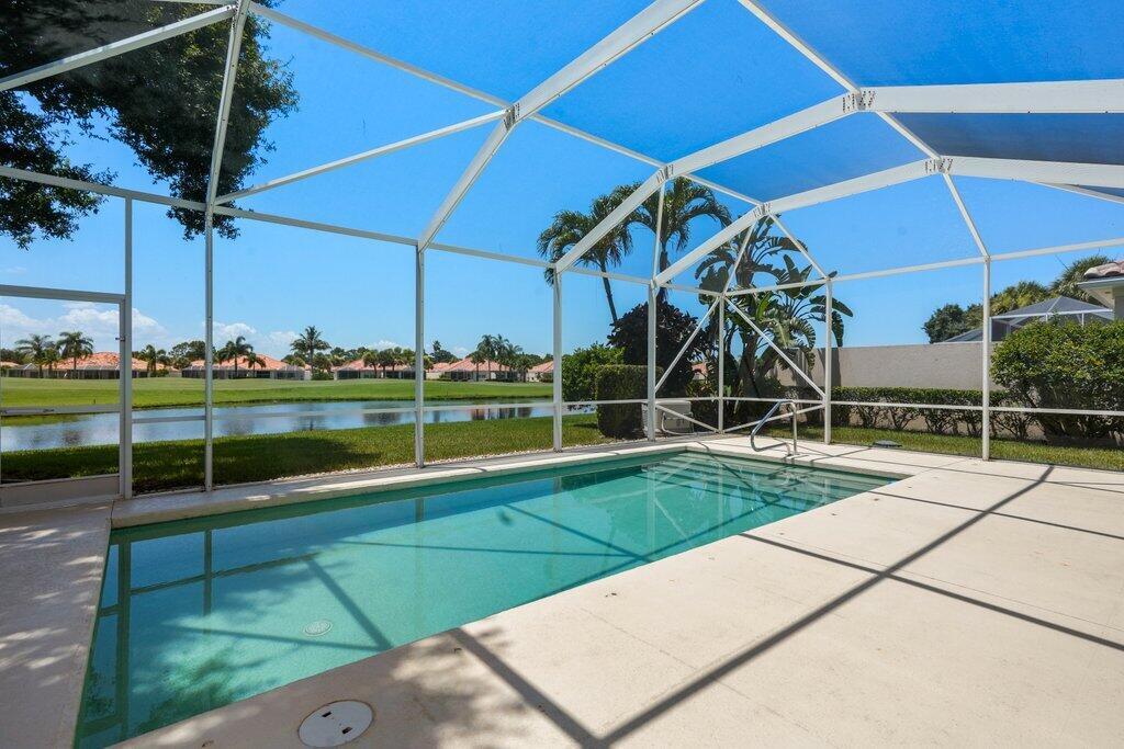 Welcome to 8232 SE Palm Hammock Lane, a meticulously maintained 3-bed, 2-bath home in the gated Lost Lake Golf Club community. This light-filled home features a new roof, partial impact windows (5), new A/C, whole home generator, private screened pool, and a 2-car garage with extra storage. Enjoy nearly 2,000 sq ft of open living space with vaulted ceilings and a spacious primary suite that opens to the pool. Relax with serene views of the lake and golf course, while still feeling extremely private and secluded thanks to lush landscaping. Lost Lake offers golf, tennis, pickleball, pools, trails, and optional memberships. HOA includes lawn care, cable, and internet. Your unique touch is all that's missing!