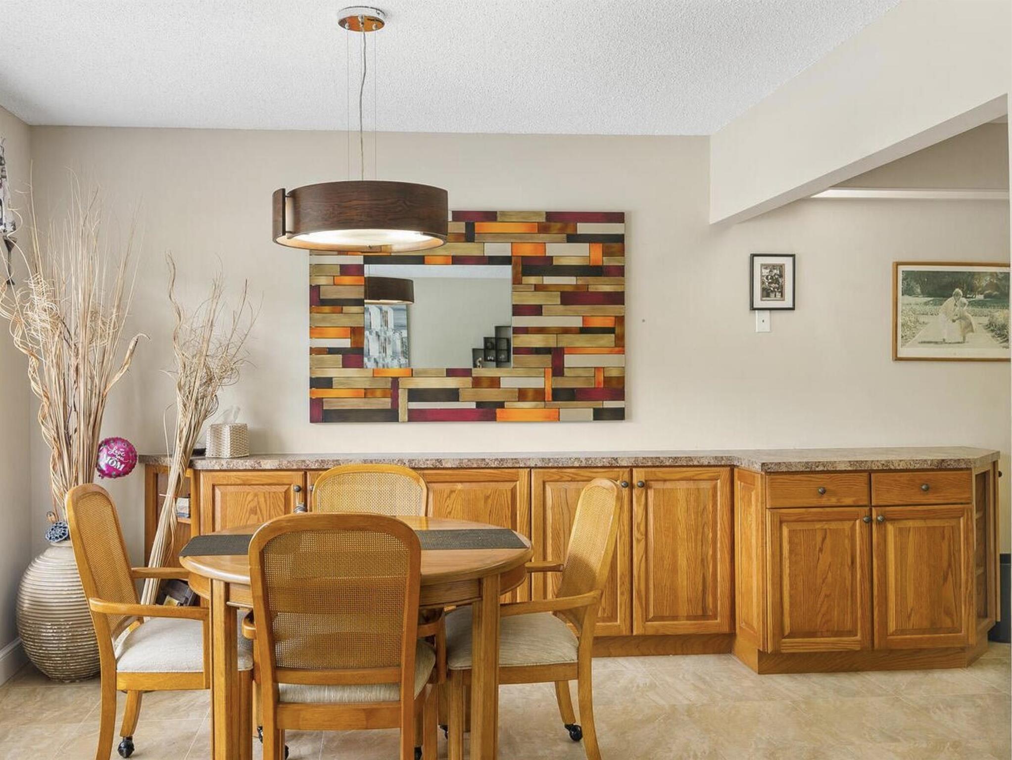 Wonderful First-Floor Water View Condo in Century Village's Desirable Wellington Section!Step into comfort and convenience with this beautifully maintained 1-bedroom, 1.5-bath condo offering serene water and green space views from the enclosed lanai. Located on the first floor, just steps from your assigned parking spot, this home is ideal for easy living.Enjoy an updated kitchen featuring extended cabinetry into the dining area, modernized bathrooms, and custom closet systems that maximize storage. The condo is tastefully finished in neutral tones, making it move-in ready. Additional peace of mind comes with a newer AC and water heater (both approx. 2 years old).Century Village is a vibrant 55+ community known for its resort-style amenities and social lifestyle