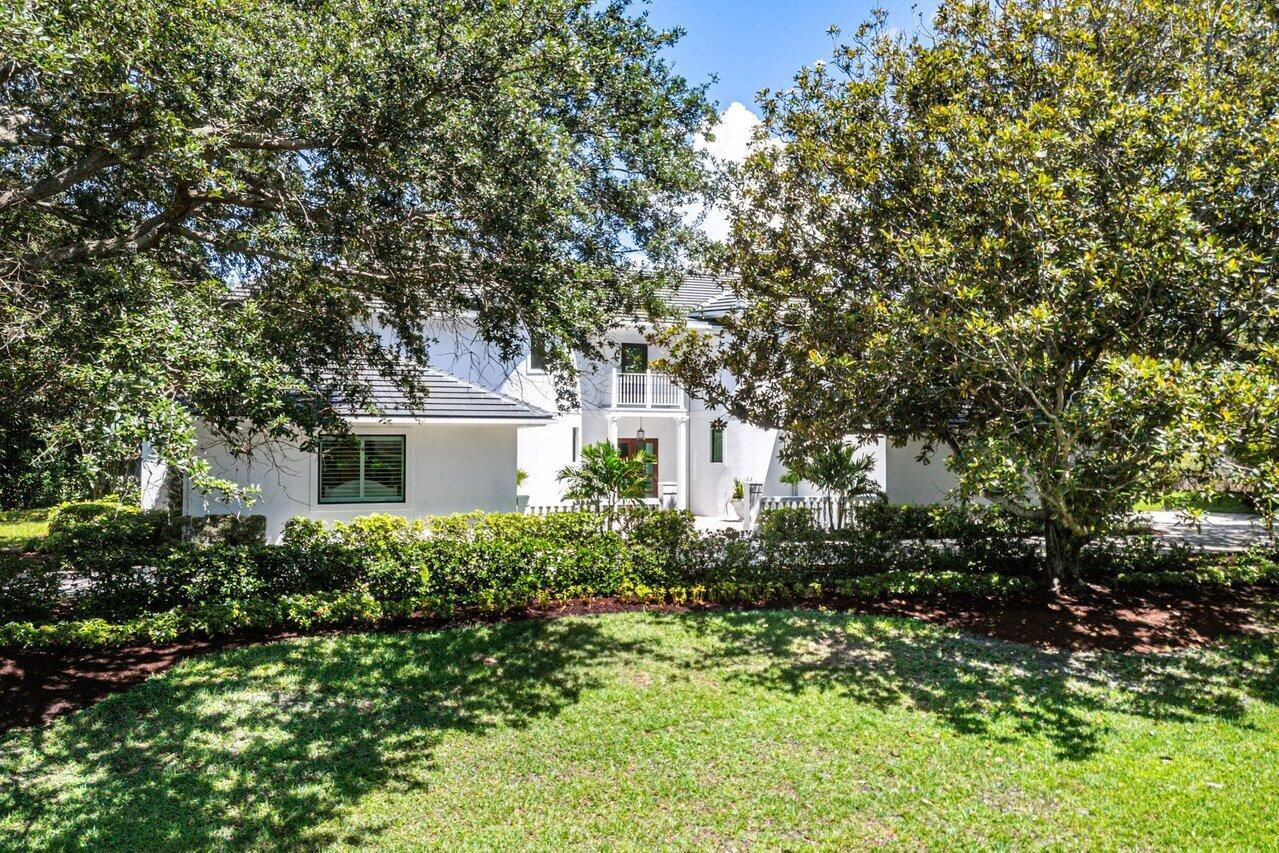 A rare opportunity awaits to own a fully renovated single-family home in the exclusive, private, gated golf community of Jupiter Hills--with no membership required (though optional). Situated on a beautifully landscaped half-acre lot with highly desirable southwestern exposure, this impeccably updated residence overlooks the scenic fairways of one of Florida's most prestigious golf courses. Designed with a sophisticated blend of modern luxury and timeless elegance, the home welcomes you with a dramatic two-story foyer featuring gleaming white marble floors and custom arched impact-rated windows and doors throughout.The main living space is spacious and refined, flowing seamlessly into a gourmet kitchen outfitted with chef-grade WOLF appliances, double ovens, an oversized Sub-Zero