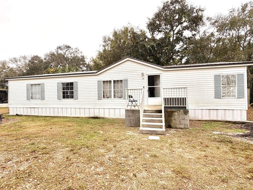 This 4-bedroom, 2-bath mobile home sits on a desirable double lot totaling approximately 1/2 acre, offering plenty of space both inside and out. The home features a mix of carpet and wood flooring, a durable metal roof, and hurricane impact windows throughout. Major systems have been updated, including a newer A/C and water heater, along with a new water pump for the well system--providing peace of mind on some of the bigger-ticket items. Whether you're looking for a primary residence or an investment opportunity, this property presents a practical option with room to make it your own.Measurements are approximate. Buyer to do own due diligence regarding measurements. ALL REASONABLE OFFERS CONSIDERED.