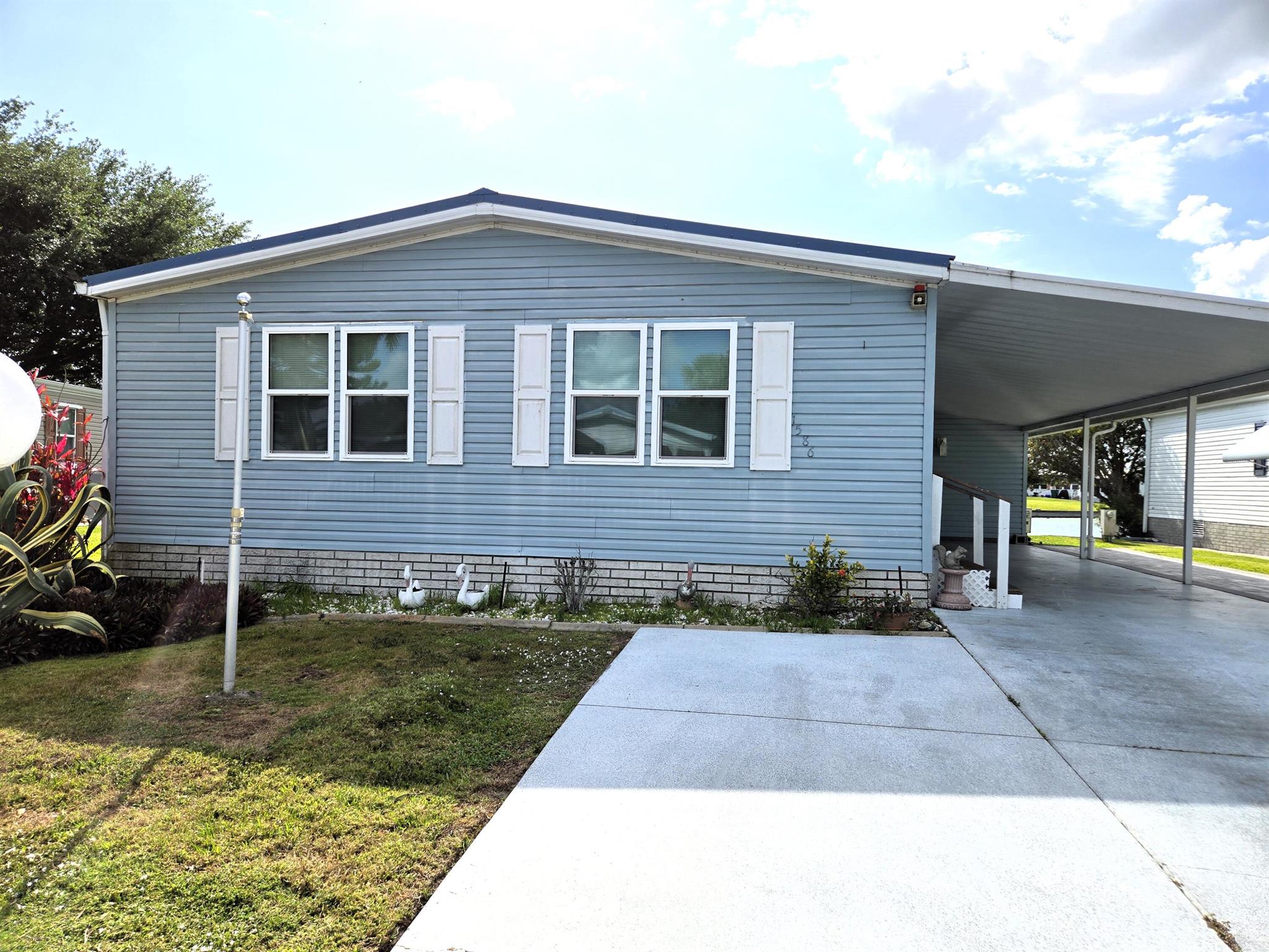 SEMINOLE COVE - WATERFRONT - DWMH with 1,296 sf under air/1,872 sf total lvg. this 2 bdrm/2ba home offers relaxing views of the lake. Updated kitchen with tons of storage. Closet pantry, Breakfast area/bar. New flooring in living room, bedrooms & den. Impact resistant windows. Florida room overlooks lake and includes a window for the ''furry'' kids to watch the ducks play in the water. Indoor laundry closet. Workshop. Covered carport with enough room for the boat. Active community with plenty of activities.