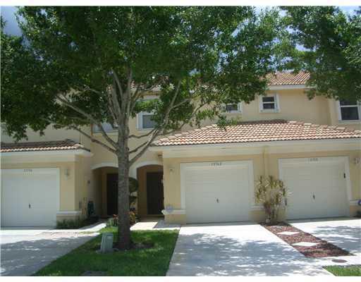 Welcome to this charming 2/2.5/1 townhome in the heart of Wellington! This lovely townhome boasts a beautiful, recently remodeled kitchen that's sure to inspire your inner chef. You'll find a spacious island with elegant quartz countertops, pristine white cabinets, & top-of-the-line stainless steel appliances. The kitchen seamlessly flows into the rest of the home, where you'll appreciate the durable & stylish LVP wood-like flooring throughout, providing a modern touch & easy maintenance. The living room is a cozy space, featuring a built-in entertainment center that's perfect for movie nights & flanked by Murphy beds on each side. Step outside to the screened-back porch and savor the tranquility of a green backyard view, a perfect spot for enjoying your morning coffee or evening su