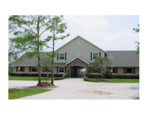 Hack to WEF. 12-stall show barn with 2 bedroom/2 bath apartment situated on 4 acres. Six large grassy paddocks, large stalls with fans and mats, wash racks with hot/cold water, laundry room. All weather ring and grass riding field, on the bridle path for quick hack to showgrounds.