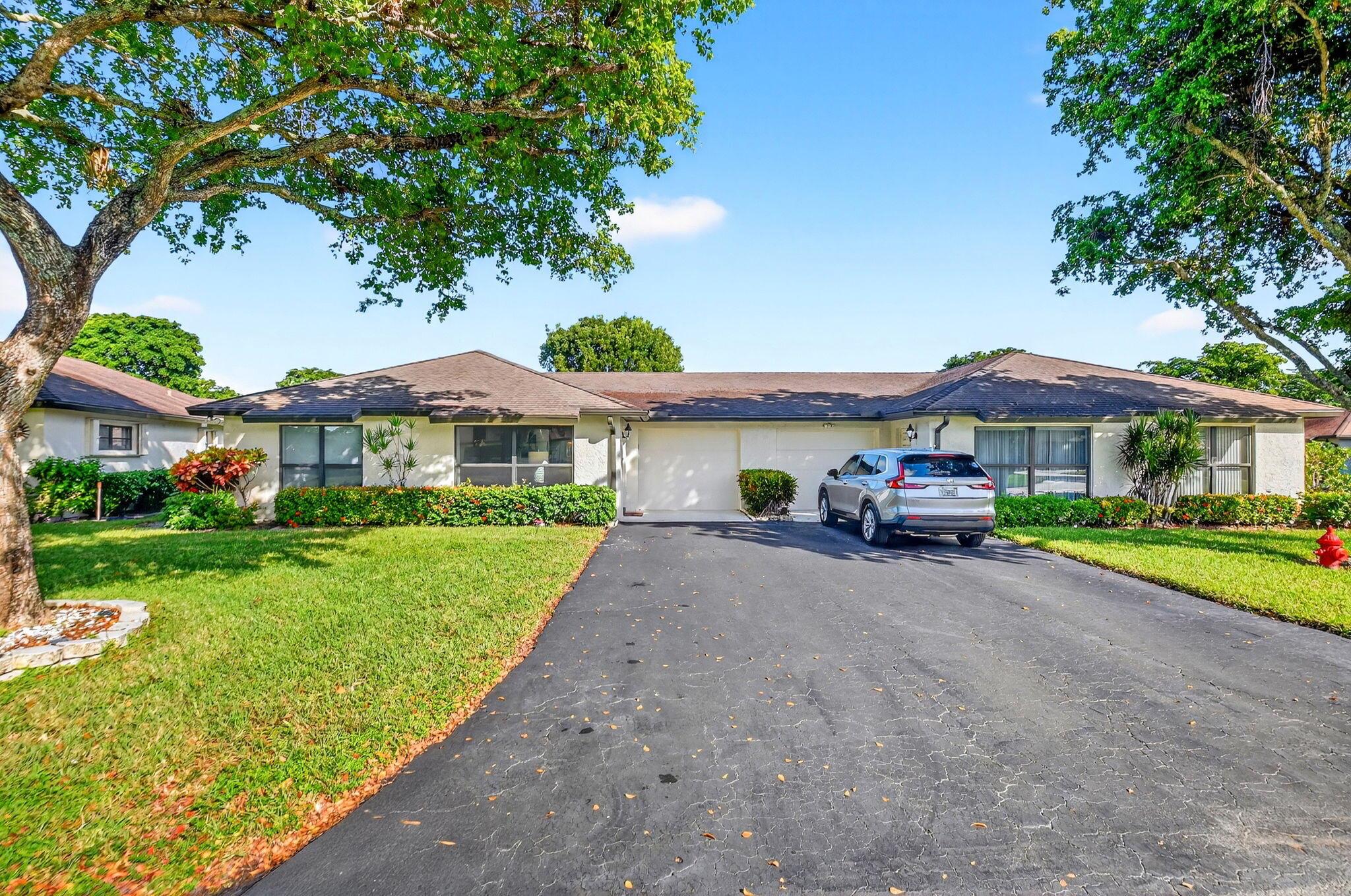 Discover easy South Florida living in this spacious 2-bed, 2-bath villa in the desirable 55+ Greentree Villas. Bright, open layout with large living area, updated kitchen, and enclosed Florida room perfect for relaxing or entertaining. Primary suite features walk-in closet and private bath. Enjoy a one-car garage, in-unit laundry, and tile flooring throughout. Community offers pools, clubhouses, and maintenance-free living with cable, water, and lawn care included. Minutes to shopping, dining, and beaches!