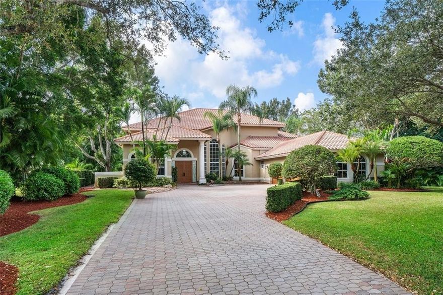 A breathtaking floating staircase, soaring 2 story ceilings & glorious lake views via walls of impact glass take center stage in this stunning estate home with a true guest house (not a studio). The open & gracious design allows for large living areas drenched in natural light, is perfect for large-scale gatherings & seamlessly flows to the impressive pool/spa area. The expansive kitchen/family room area features an island/fine wood cabinetry/top-of-the-line appliances/granite countertops & a fireplace. The beautiful Primary suite is impressive in size & has a sitting area/luxurious spa-like bathroom/new balcony. The separate guest house offers a large full kitchen/living room/large master suite/screened porch & peaceful water views. Perfect for a Multi-Generation household! Other Offerings, All impact windows & doors, full house generator, gas tankless water heater, Full-service summer kitchen, new A/c in the main house,