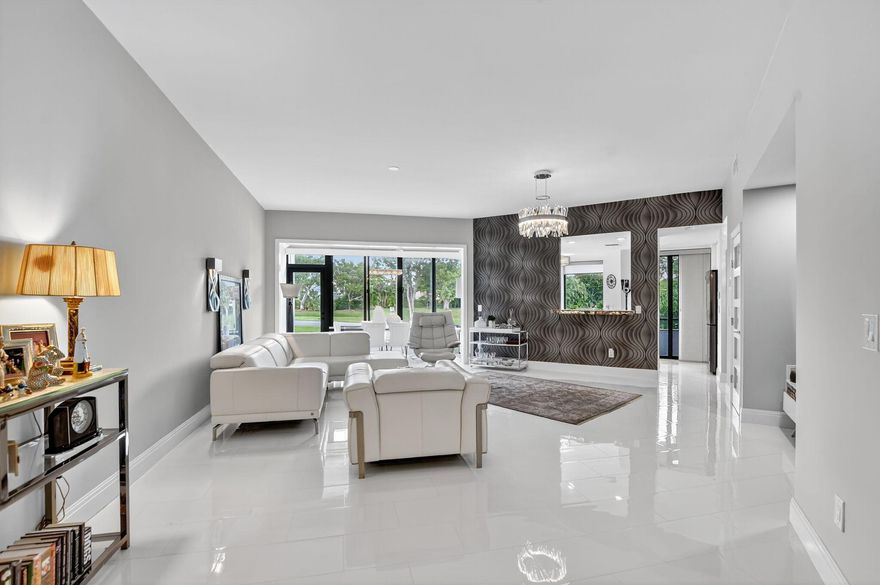 Fully renovated 2BR/2BA ground-floor corner condo in La Paz at Boca Pointe, an all-ages, guard-gated community with optional club membership. 1,636 total sq ft (includes Florida room & lanai) with no stairs or elevators required. Modern kitchen with white gloss cabinets, quartz leather counters, backlit stone geode pass-through, and Samsung appliances. Dining room opens to a glass-enclosed Florida room with walkout access and tranquil lake and garden views. Kitchen and primary suite open to a screened lanai. Porcelain tile floors, motorized blinds, full impact glass, and storm shutters. Primary bath features jetted tub, frameless shower, and double vanity. Guest bath with sleek stall shower. In-unit washer/dryer, new A/C, assigned parking. Two pools, tennis, clubhouse, Covenient to ALL!