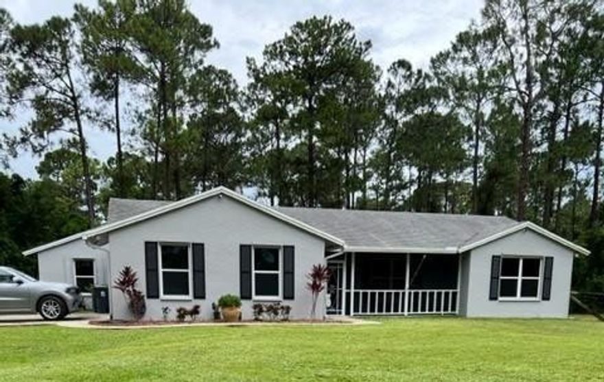 Immaculate Acreage home! Split Floor plan! Three bedrooms, two baths, two car side entry garage located on gorgeous high and dry one acre + lot NO Pond! Screened front porch opens into spacious wide open floorplan. Large kitchen with granite, breakfast bar, wood cabinetry and large pantry, walk-in closets in all the bedrooms, tile throughout, updated bathrooms, enormous family room, cabana bath, tinted windows, extra long concrete driveway and fenced rear yard! Large covered and screened patio, above ground pool with saltwater system, CBS construction, hurricane panels, security system and more! Great location, close to schools, parks and shopping.