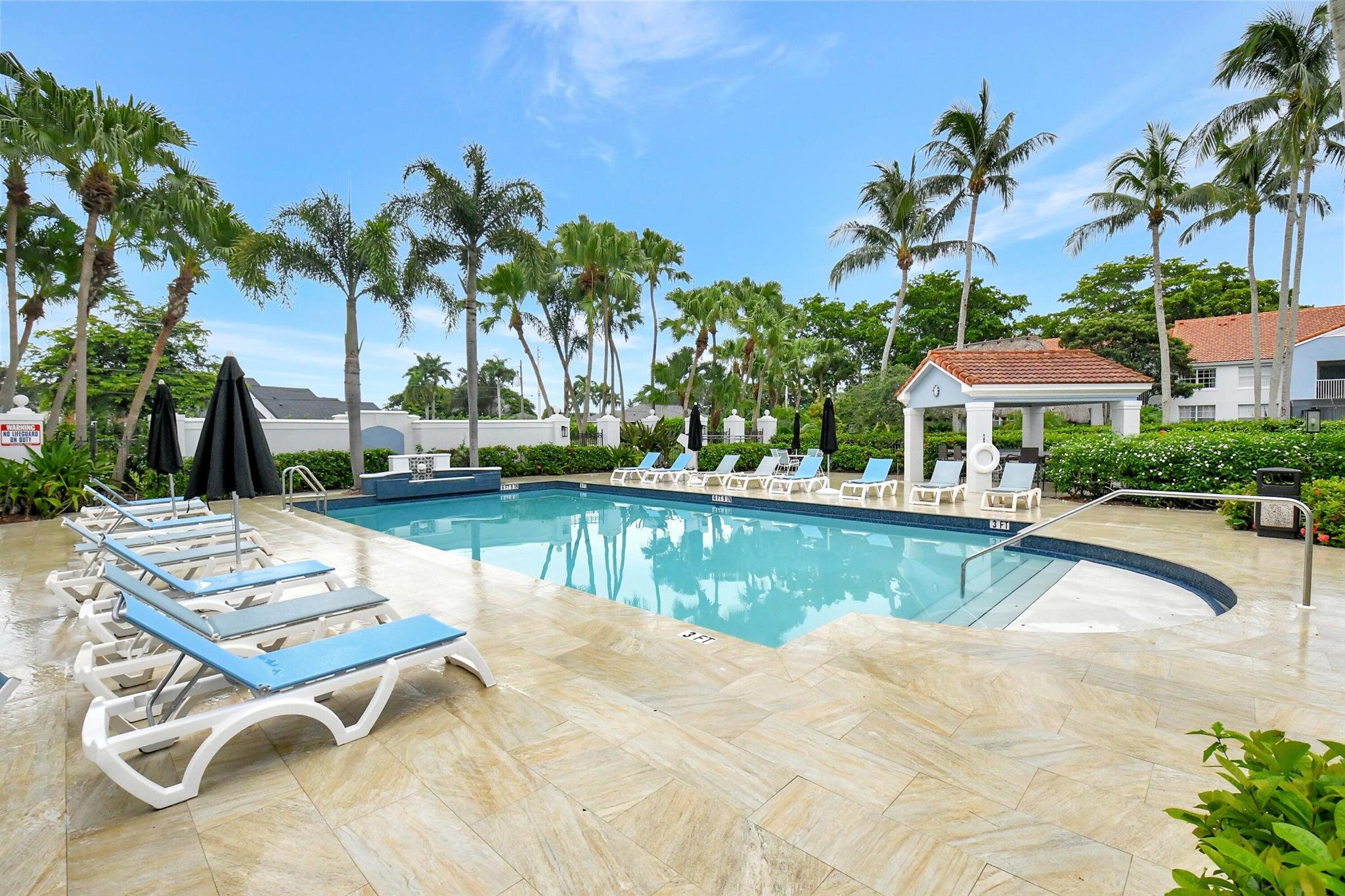 Discover refined living in this renovated 3BR/3BA ground-floor corner residence at The Bocar, a sought-after gated community in Boca Raton. Spanning approx. 1,500 sq. ft., this home showcases marble floors, designer accent walls, and an open layout flowing into a gourmet marble kitchen. The primary suite offers dual closets, including a walk-in, and a spa-inspired bath with soaking tub, double vanities, and glass shower. A second en-suite bedroom with walk-in closet and a bright third bedroom with French doors provide flexibility. Enjoy a screened patio and exclusive amenities--resort-style pool, clubhouse, tiki hut, fitness center, tennis, racquetball, and more. Two assigned parking spaces (1 carport). Investor-friendly, A+ schools, near pristine beaches, fine dining, shopping & highways.