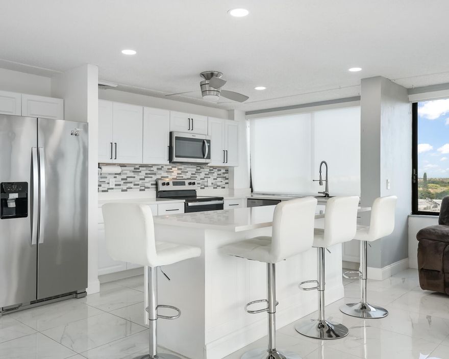 Top-floor corner penthouse unit in a boutique,  all age-friendly building at Yorktown Condo where you have panoramic views from every room. Enjoy large porcelain tile throughout, white kitchen cabinets, bright white granite countertops, kitchen island with storage, and stainless steel appliances. Other features include updated bathrooms, newer lighting, and a relaxing balcony to enjoy the scenery. Luxury living at an affordable price in a private, low-density building in one of West Palm Beach's best locations. Walk to Tanger Outlets (restaurants & shops);  and close to major roads and highways. Come see this spectacular unit today and make it your very own.