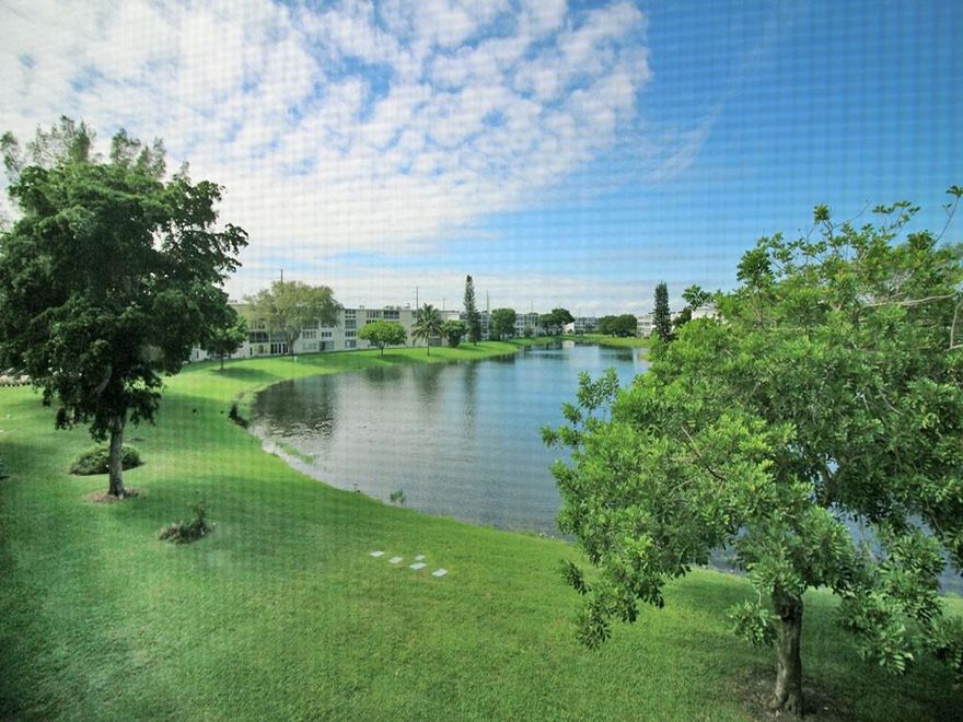 AMAZING OPPORTUNITY!  This charming & bright 2 bedrm, 1.5 bath comes furnished & has a BEAUTIFUL VIEW OF THE LAKE. Priced to sell & ready to move rt in, features incl white cabinets & appl & over cab ltg in kit, tile thru-out, tub/shower combo in primary bathrm & ceiling fans in every rm for added comfort! Enjoy the encl patio w/tile flrs & sliding glass doors, showcasing a gorgeous, expansive lake & fountain view with a stunning sunset exposure. Lovely community picnic area in front of bldg. to enjoy those social evenings! This 24/7 gated community offers free busses, pools, pickleball, tennis, putting green, shuffleboard, State-of-the-Art Clubhouse w/gym, sauna, cafe, clubs, classes, theater, movies & much more! Close to beaches, shopping & dining!  THIS ONE WON'T LAST! Assoc. Claims 55+