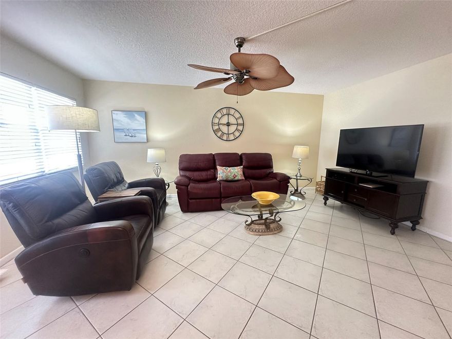 AMAZING OPPORTUNITY!  This charming & bright 2 bedrm, 1.5 bath comes furnished & has a BEAUTIFUL VIEW OF THE LAKE. Priced to sell & ready to move rt in, features incl white cabinets & appl & over cab ltg in kit, tile thru-out, tub/shower combo in primary bathrm & ceiling fans in every rm for added comfort! Enjoy the encl patio w/tile flrs & sliding glass doors, showcasing a gorgeous, expansive lake & fountain view with a stunning sunset exposure. Lovely community picnic area in front of bldg. to enjoy those social evenings! This 24/7 gated community offers free busses, pools, pickleball, tennis, putting green, shuffleboard, State-of-the-Art Clubhouse w/gym, sauna, cafe, clubs, classes, theater, movies & much more! Close to beaches, shopping & dining!  THIS ONE WON'T LAST! Assoc. Claims 55+