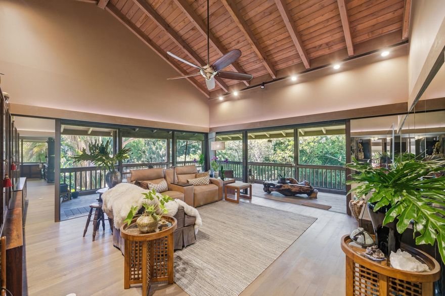 Welcome to your private retreat in Boca West's coveted Plantation Colony community. Named "Plantation," after the classic tropical architectural roof style, with wrap-around screened lanais providing shade for an indoor-outdoor living experience. This community is prized for its separate island-like courtyards, mature landscaped meandering paved paths, and an exclusive community pool area with Old Florida Chickee huts, BBQ areas, and wood decking extending over the main waterway.  The interior emphasizes a dramatic great room that features a soaring exposed-beam cathedral ceiling, solid hardwood flooring (installed during updates), sliding glass doors that open to a shady wrap-around screened lanai, and vintage mirrored walls that visually extend the surrounding greenery, natural light, and wildlife, creating an immersed-in-nature experience.  This unit underwent a complete renovation in 2020. Part of the renovation includes hardwood flooring, a 2020 HVAC system with new ductwork, new drywall and insulation, electrical rewiring, and a tankless water heater. Interior reconfiguration expanded and added closet space, raised select ceilings, and included new flooring throughout. The residence is located in an end courtyard with a hidden side entry that offers seclusion with no direct sightlines to neighboring residences. A covered parking space is discreetly located behind mature landscaping, with additional guest parking available. BOCA WEST'S ENTRY FEES AND DUES NOT INCLUDED. CURRENTLY AT $150,000, THE ENTRY FEES ARE SET TO INCREASE TO APPROXIMATELY $235,000 IN SEPTEMBER 2026.