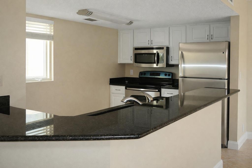 Photo of 1030 Lake Shore Drive #206, Lake Park, FL 33403 (MLS # R11167891)