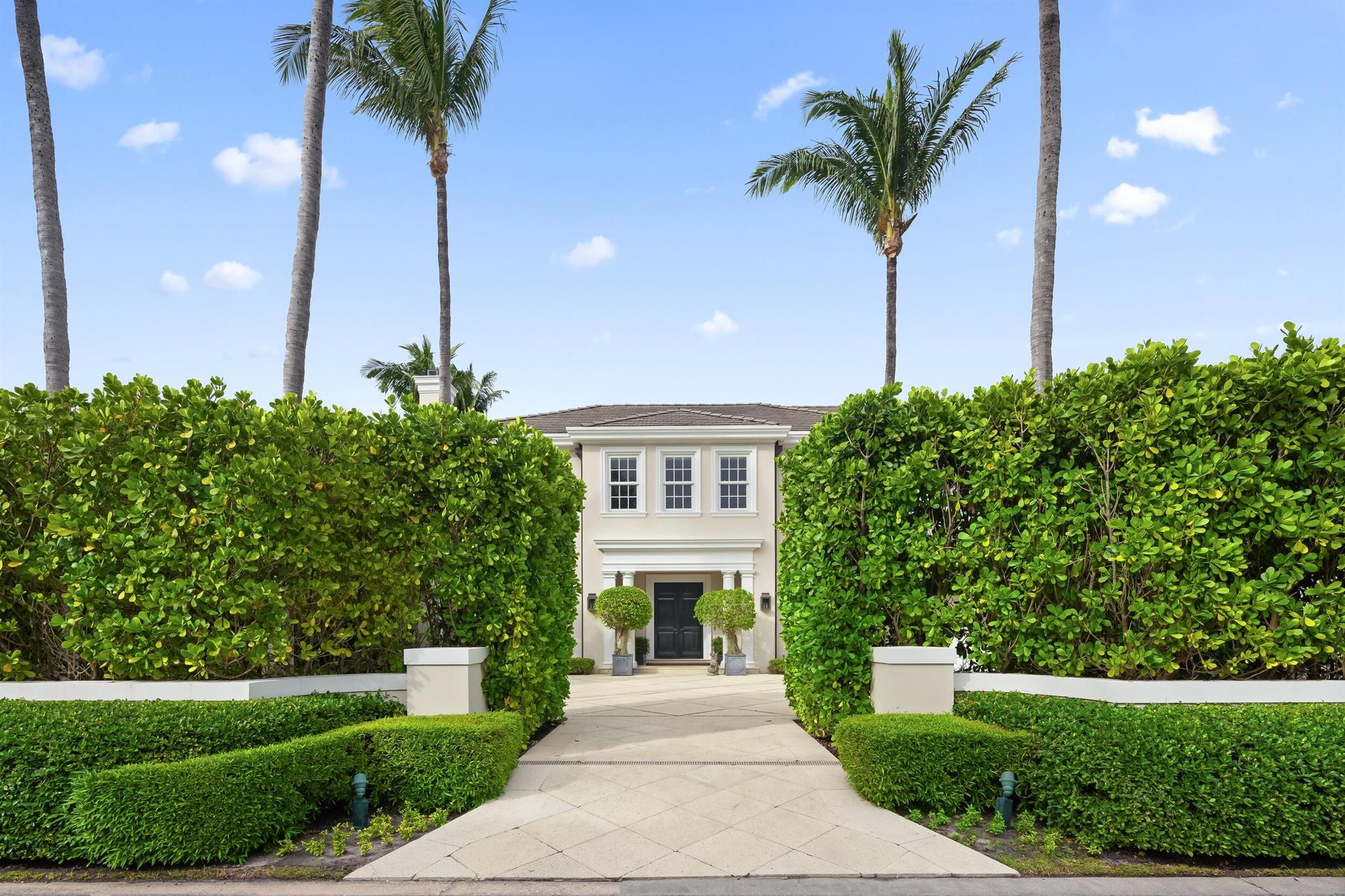 Located in Palm Beach's estate section, 153 Kings Road is a turnkey, Georgian-style home with modern amenities spanning nearly 6,800 total square feet. Built in 2009 by famed architect Tom Kirchhoff and tastefully designed by Colefax and Fowler, the home was featured in ''The Pearls of Palm Beach'' by Holly Holden. A double-height foyer presents high ceilings on both floors & leads to the living room, library, dining room, and chef's kitchen. The chef's kitchen includes a 6-burner gas range, dual ovens, two dishwashers, two refrigerators, a breakfast room, and a butler's pantry. French doors lead to a large, resort-style pool area.The second-floor primary suite, accessible by stairs or elevator, features two full baths, a study, and large walk-in closets. Four additional bedrooms