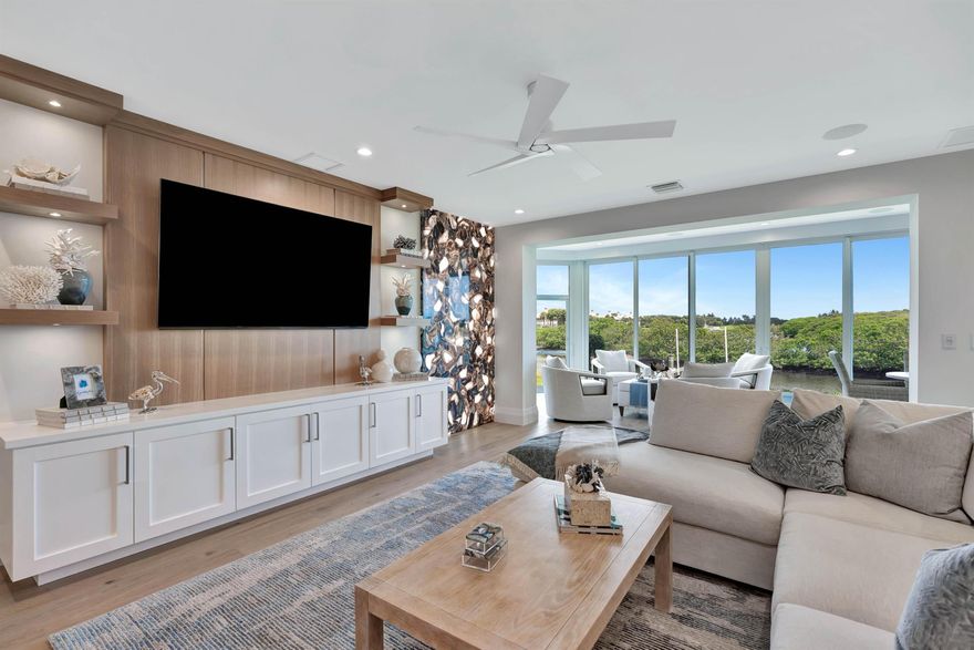 Discover the epitome of luxury living in the heart of Admirals Cove, where this impeccably renovated waterfront masterpiece awaits. Located on the prestigious Eagle Drive, this Harbor Home has been meticulously transformed with no detail overlooked, offering breathtaking long water views of the serene mangrove islands. Constructed with sturdy concrete block and equipped with impact windows and doors, this home is designed for both beauty and durability. Boating enthusiasts will appreciate the no-fixed-bridge access and a private slip accommodating up to a 40-foot vessel.