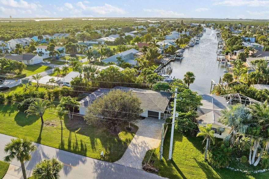 WATERFRONT GEM WITH A PRIVATE DOCK, OCEAN ACCESS & NO FIXED BRIDGES! Located on the desirable south end of North Hutchinson Island. Combining classic Old Florida charm with modern upgrades. Just minutes by boat to the Fort Pierce Inlet. The west-facing backyard offers stunning long views down the tidal canal and showcases spectacular evening sunsets. Enjoy an open-concept kitchen and living area, 3 spacious bedrooms, and 2.5 bathrooms, along with a 1-car garage. Recent improvements include a new roof, hurricane straps, and an impact-rated skylight (2022), providing peace of mind and lasting value. Fish from your private dock, watch the manatees play, or stroll to the nearby beach--this is true island living at its best. Currently a successful Airbnb. Showings organized around guests.