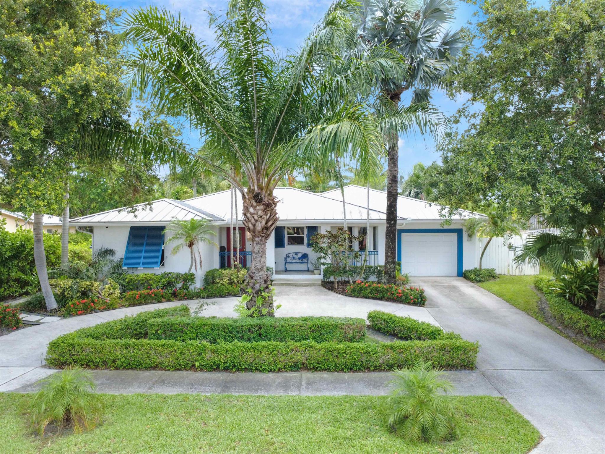 Move-in ready! 3BR/3BA home on a quiet, dead-end street with lush landscaping, circular driveway, 1-car garage, and a charming front porch. Open-concept layout with wood flooring, bay window, and plenty of natural light. Updated kitchen with custom wood cabinetry, quartz counters, SS appliances, and large eat-in island perfect for entertaining. Spacious primary suite with private patio access, walk-in closet & spa-like bath. Second primary suite ideal for guests or multi-generational living. Impact-rated French doors lead to a screened-in patio with cypress T&G ceilings & ceiling fans. Fenced backyard with gazebo, powered shed, and room for a future pool. No HOA, no rental restrictions. 2 new A/Cs 2024, metal roof, gas water heater/dryer, & central vacuum. Minutes to beaches and airport!