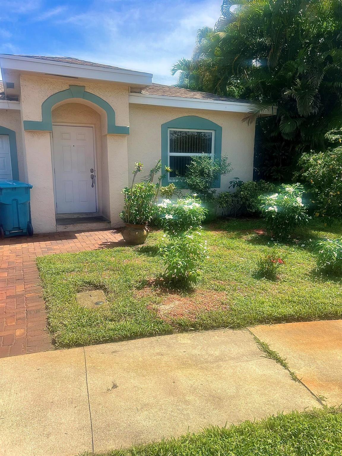Welcome home to this beautiful residence, featuring hurricane-impact windows and sliding glass doors that open to a private patio lined with graceful palm trees, plus a spacious backyard that offers the perfect setting for relaxation and comfort.