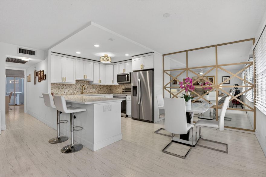 Rarely available, beautifully updated first floor residence in the highly desirable 55+ community of Century Village East! This light & bright home features a stunning renovated kitchen with white shaker cabinetry, quartz countertops, designer backsplash, stainless steel appliances, and elegant gold accents. Enjoy the open-concept layout with a spacious breakfast bar. The updated bathrooms offer modern finishes, sleek vanities, and glass-enclosed showers. Neutral flooring flows seamlessly across the living areas. Relax and unwind in the enclosed patio with tranquil garden views. Century Village East offers resort-style living with a state-of-the-art clubhouse, indoor and outdoor pools, fitness center, theater, tennis, pickleball, courtesy transportation, and endless clubs and activities.