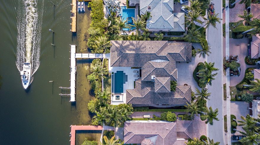 NO SHOWINGS UNTIL DECEMBER 28, 2021**  Coastal Contemporary Elegance! Located On One Of The Few Lots In Harbour Isles With 100' Of Deep Water Frontage. Can Accommodate Up To An 80' Vessel! Private Views Of The North Palm Golf Course. Only 750 Feet From The Intracoastal! 
This Estate Home Has Just Undergone A Complete Renovation From The Roof To The Floors. New Renovation Includes 1,728 Of Additional Living Space For A Total Of 7,058 Of Living Area, A Beautiful New 500 Sq. Ft. Second Level Lanai Giving You A Panoramic View! Five En-Suite Guest Bedrooms! Totally Renovated Master Bed And Bath, Offering His And Her Bathrooms And Large Walk In Closets! All Obstructive Interior Walls Have Been Removed To Give Million Dollar Views From Every Room!