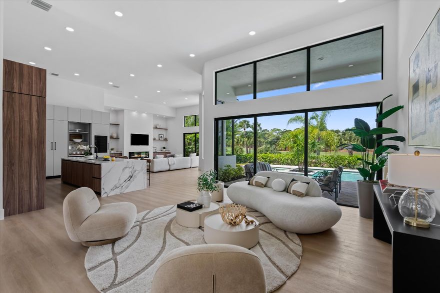 Rarely available, this beautifully remodeled contemporary Breakers West estate home boasts 3 ensuite Bedrooms + an Office, 3.5 baths, and 2 car + golf cart garage and is ideally positioned to capture endless sunset views of the Breakers West Rees Jones golf course, several lakes, and pool views. Thoughtfully redesigned with exceptional attention to detail, this 3,400 SF residence features a NEW tile roof, NEW impact windows and doors, NEW impact garage doors, 2 New HVAC systems, and a NEW hot water heater.  Inside, soaring 14-foot ceilings complement the modern kitchen with European-designed Grober custom cabinetry with quartz countertops,  neutral luxury vinyl flooring throughout, large format porcelain tile floors in the bathrooms, and an electric fireplace in the family room beautifully compliment updated living areas. The 8ft kitchen island with quartz waterfall edge countertops will be the center of this gourmet kitchen. Designed with ample cabinet storage, this entertainer's  kitchen has a custom appliance package including a 5 burner Wolf induction cooktop, 48" JennAir built-in refrigerator, Jennair combo micro/convection oven plus wall oven, wine refrigerator with 2 refrigeration drawers, Asko dishwasher and built-in area for a coffee or espresso bar.  The luxurious primary suite features state-of-the-art of bathroom that rivals any bathroom at the Four Seasons hotel!  It features large walk-in shower with dual shower heads and body sprays, a separate steam shower, a soaking tub, and separate quartz vanities positioned on opposite sides with abundant counter space and tiled walls.  Outside, enjoy one of the most special views in all of Breakers West,  a private pool and spa in a serene setting to take in the sunset views.  Breakers West offers 2 manned guard gates and roving patrol security. Various club memberships are available at either Breakers West or Mayacoo Lakes Country Club for golf and sport/social membership (including The Breakers Palm Beach Beach club access in the summers months).  Breakers West is conveniently located to downtown West Palm Beach, Cityplace, Nora District and Palm Beach. Just 15 minutes to PBI and Wellington's world-class equestrian amenities.