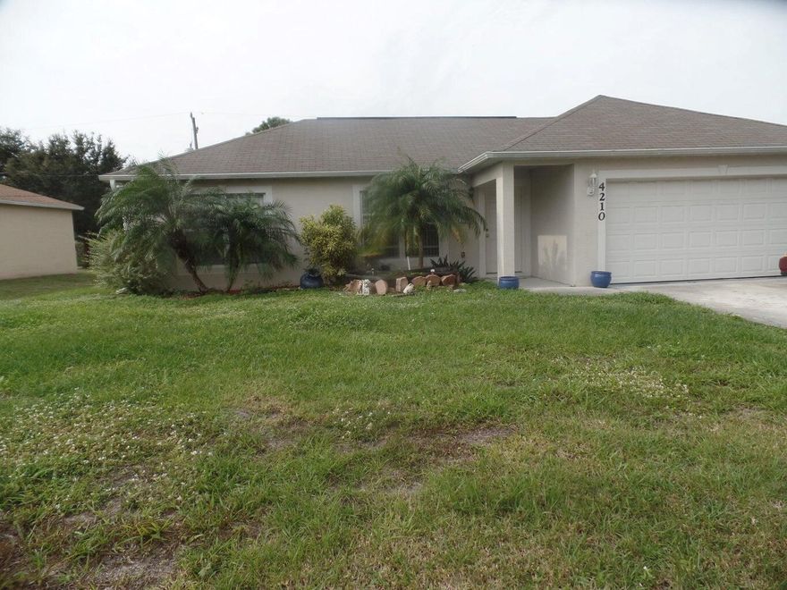 Fresh pained 3 bedroom, two Bath, two car garage. Tiled throughout. Screened patio with large backyard, fruit trees, minutes to I95, shopping and schools.