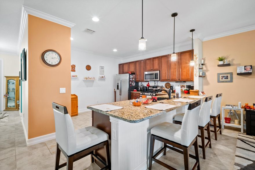 Enjoy low-maintenance living with lower insurance cost in this 2018 CBS-built 3BR, 2BA home offering 1,920 sq ft of open, functional living space. Tile flooring runs throughout main areas, leading into a modern kitchen with quartz countertops, stainless steel appliances, gas range, and ample cabinetry. The layout flows into living and dining areas and out to a screened patio overlooking a peaceful pond. The primary suite features dual walk-in closets, double vanities, and a tiled shower. Additional highlights include a concrete tile roof, impact windows, impact slider door, fenced yard, and two-car garage. HOA covers exterior maintenance for added convenience. Located in a gated community minutes from I-95 and St. Lucie West shopping, dining, and medical.