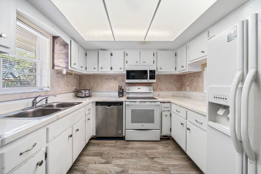 PRICED TO SELL. Come find your North Palm oasis. Nestled right in the heart of North Palm Beach is this 2nd story end unit. This spacious 2-bed and 2-bath unit bolsters tons of natural light, and full hurricane shutters throughout. Unit just needs some TLC to make it your own. Newer roof (4 years old) and newer a/c (Feb 2022),  Step outside to two private community pools, a BBQ area, and a clubhouse. Come with the peace of mind and relax near all of the great shopping, boating, beaches, golf, parks, and restaurants that North Palm has to offer!