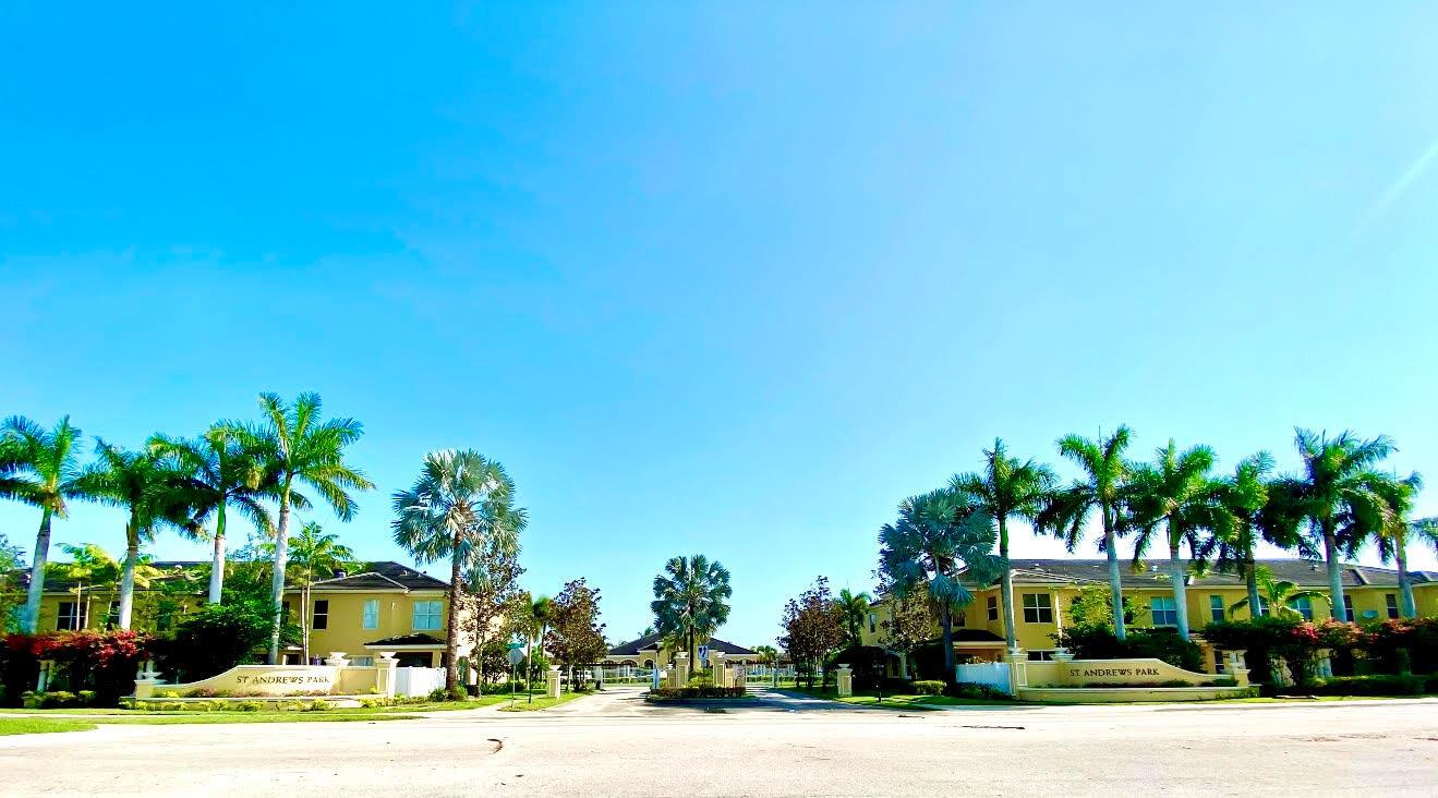 Turn-Key Townhome Living in St. Andrews! Experience the best of Port Saint Lucie with this sophisticated and private townhome in the well-established community of St. Andrews. High ceilings and a flowing, open-concept layout create an airy and expansive atmosphere. The chef's kitchen, a dream for entertaining, features premium stainless steel appliances, a gas range, and a large granite-topped peninsula that opens to the main living and dining area. A screened front porch and a private, covered back patio expand your living space outdoors.The second level offers quiet comfort with beautiful wood flooring throughout. The bright and spacious guest bedroom includes an attached en-suite bath, providing a private haven. The luxurious master suite serves as your ultimate sanctuary, featuring