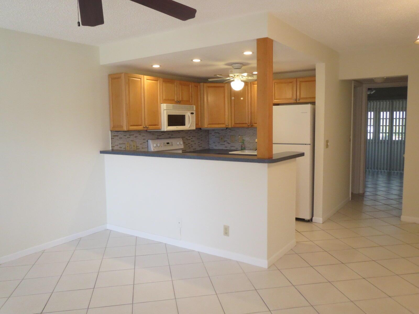 55+ community. Ground floor, parking space is right behind the back door for easy access in and out of the condo. Adorable and ready to move into. Tile throughout. Freshly painted. Newer kitchen and bath. Large storage closet. Accoridan hurrican shutters. Enclosed patio. Near Haverhill gate.