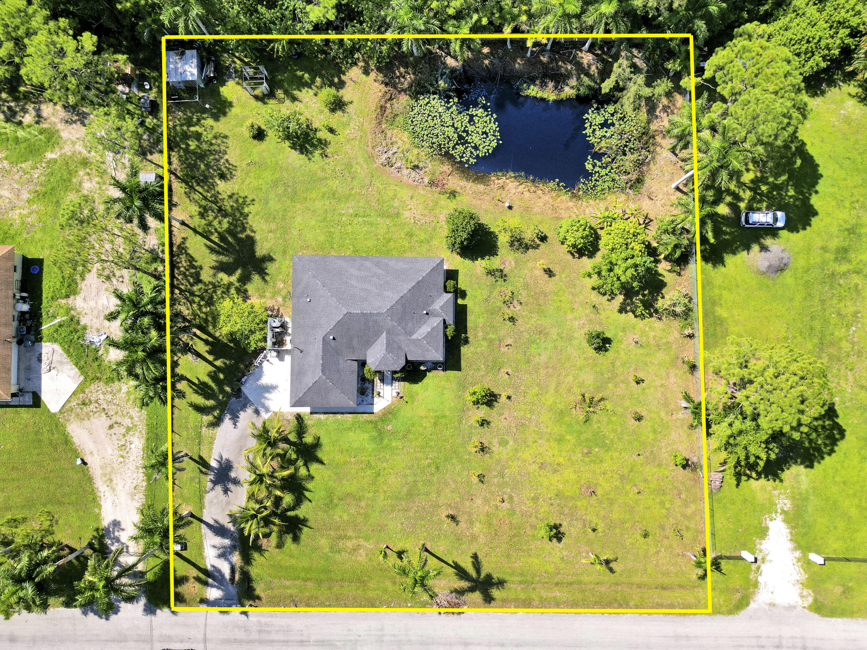 Welcome to this spacious 4 bedroom 2 bathroom home with a 2 car garage, set on a private 1.29 acre lot in The Acreage with no HOA. Built in 1998, the home offers 1,798 living sqft with a split floor plan, tile flooring in the common areas and bathrooms, and laminate in the bedrooms (No Carpet)!Highlights include upgraded bathrooms, a screened in patio, and large backyard with your very own pond. The roof was replaced in 2020 and the septic system was cleaned and inspected in August 2025. The kitchen counters and other areas need updating, giving buyers the opportunity to add personal touches. With some TLC, this property can be transformed into your dream oasis.