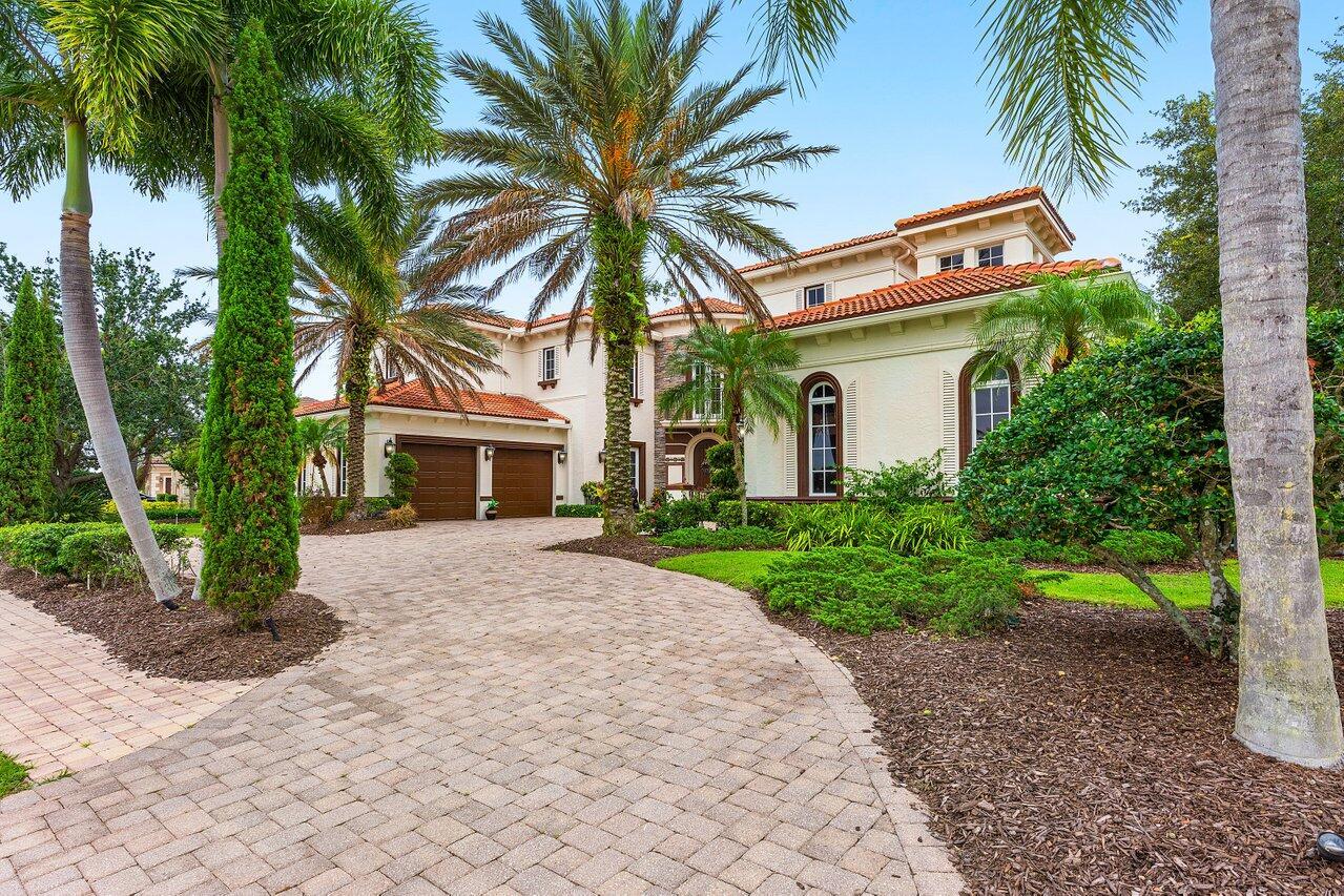 This stunning lakefront home boasts 26 ft. high ceilings & fireplace, a wall of windows stretching up 2 floors, a floating stone staircase, & screened porch with a second-floor patio overlooking the pool & cabana bath. The expansive kitchen is equipped with Viking appliances & features a island bar adjoining the family room. Living, dining, and wet bar are prime entertainment locations. The Office features custom 2-story bookcases & coffered ceilings. The primary retreat features a double tray ceiling & two spacious closets with custom cabinetry. The luxurious primary bathroom includes double water closets, double vanities, and a whirlpool tub perfect for relaxation. The Main Guest Suite has a courtyard entry & ensuite bath. Guest suites 2 & 3 are upstairs & feature a private den.