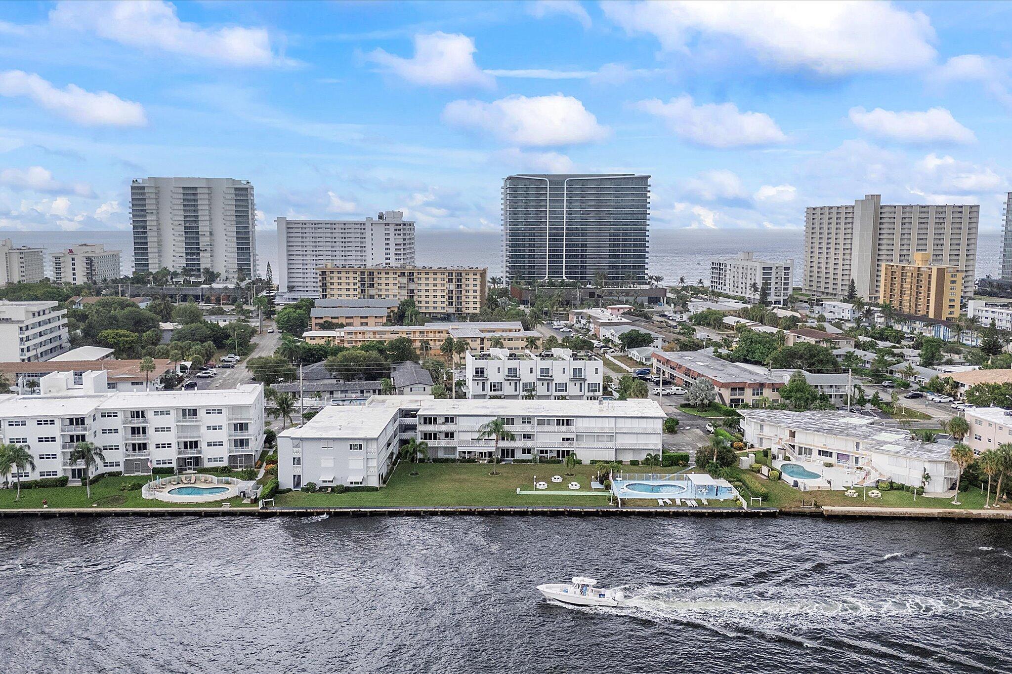Experience serene waterfront living in this beautifully updated 55+ community residence, offering stunning Intracoastal views and vibrant boating activity right outside your patio. This immaculate unit features new hurricane-impact windows and doors, sleek 24x24 porcelain tile throughout, and a kitchen with a stylish tile backsplash. The spacious bedroom includes a walk-in closet, while the bathroom showcases a walk-in shower with custom cabinetry. Enjoy peaceful evenings on your covered patio while taking in breathtaking sunsets. Added highlights include a newer electrical panel, new two-zone high efficiency A/C mini-splits, a 4-year-old hot water heater, a storage locker, and convenient shared laundry on the same floor.