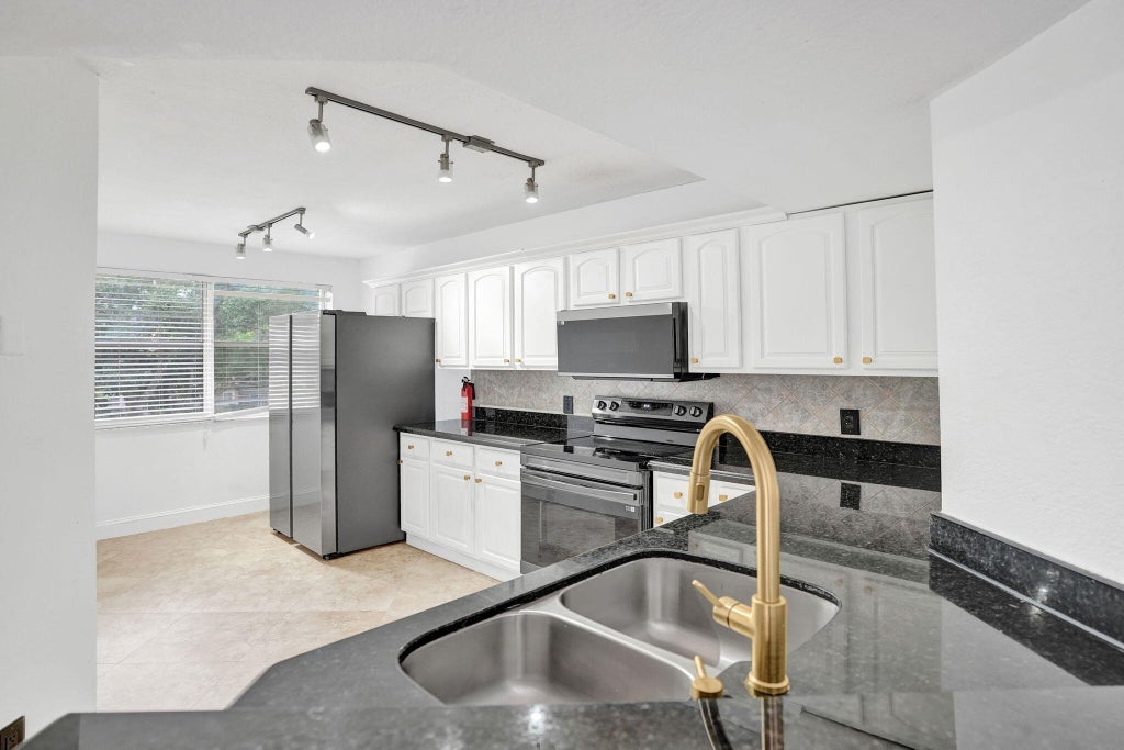 Photo of 8761 Wiles Road #301, Coral Springs, FL 33067 (MLS # B26080779)
