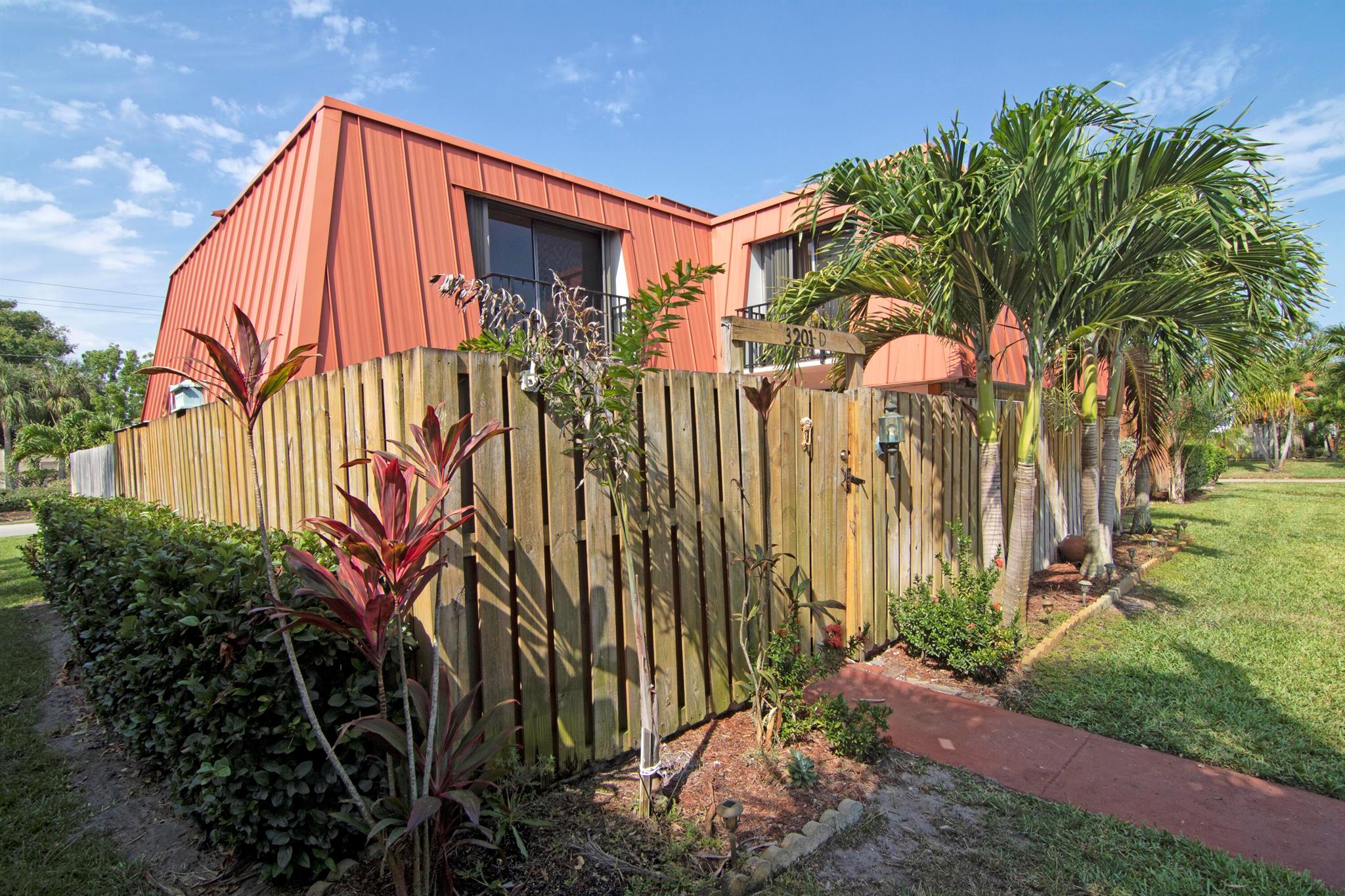 Charming 2/2 townhome centrally located in the Palm Beach Gardens. Walking distance to shopping, restaurants and hospital. This home features a large fenced patio with storage area. The interior has been tastefully updated with a completely remodeled kitchen. You will love the granite counters, updated cabinetry, tile backsplash, bead-board paneling, hardwood floors, gas range & fireplace & custom entertainment build-ins. Downstairs offers your living area, kitchen, dining area, full bathroom & laundry room. The upstairs offers 2 spacious bedrooms and a full bathroom equipped with dual sinks. Both bedrooms come with their own private balcony also. The HOA fees here are very affordable & provide basic cable & insurance on the building. This home is storm ready with all accordion shutters!