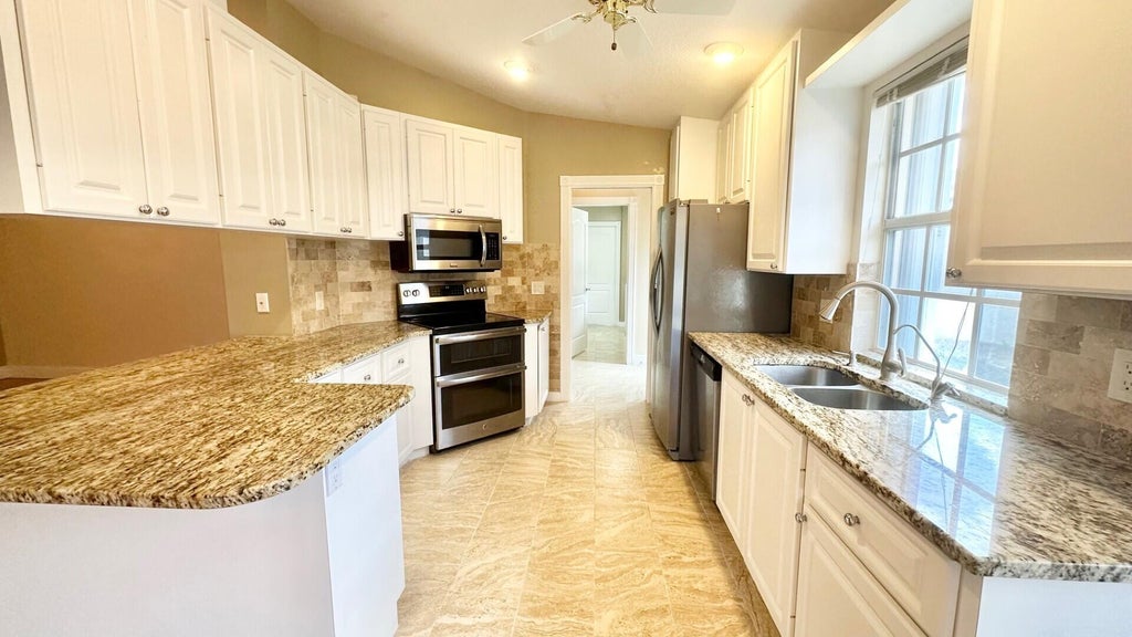 Photo of 2257 Blue Springs Road, West Palm Beach, FL 33411 (MLS # B26067937)