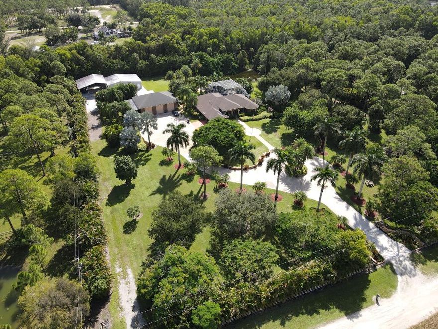 Welcome to a truly unique estate offering space, privacy, and exceptional versatility in the heart of Loxahatchee. Situated on 5 beautifully landscaped acres, this 4-bedroom plus office, 3-bathroom residence spans approximately 3,400 square feet of well-designed living space, ideal for both everyday comfort and entertaining.The home features an open, functional layout with generous room sizes, abundant natural light, and a dedicated office perfect for remote work or study. Outdoor living is enhanced by expansive grounds offering endless possibilities—gardens, recreation, or future expansion. 
Car enthusiasts, hobbyists, and entrepreneurs will appreciate the detached 3-car garage with 12-foot doors, designed to accommodate specialty vehicles, boats, or RVs. Completing this rare offering is a 2,500-square-foot metal building, thoughtfully designed as a professional-grade shop and currently outfitted as a private gym, providing unmatched flexibility for work, fitness, or creative pursuits.

This property seamlessly blends residential comfort with functional space, all within a peaceful, private settingyet conveniently located near major roads, shopping, dining, and top-rated schools. A rare opportunity to own acreage with true utility in Loxahatchee.