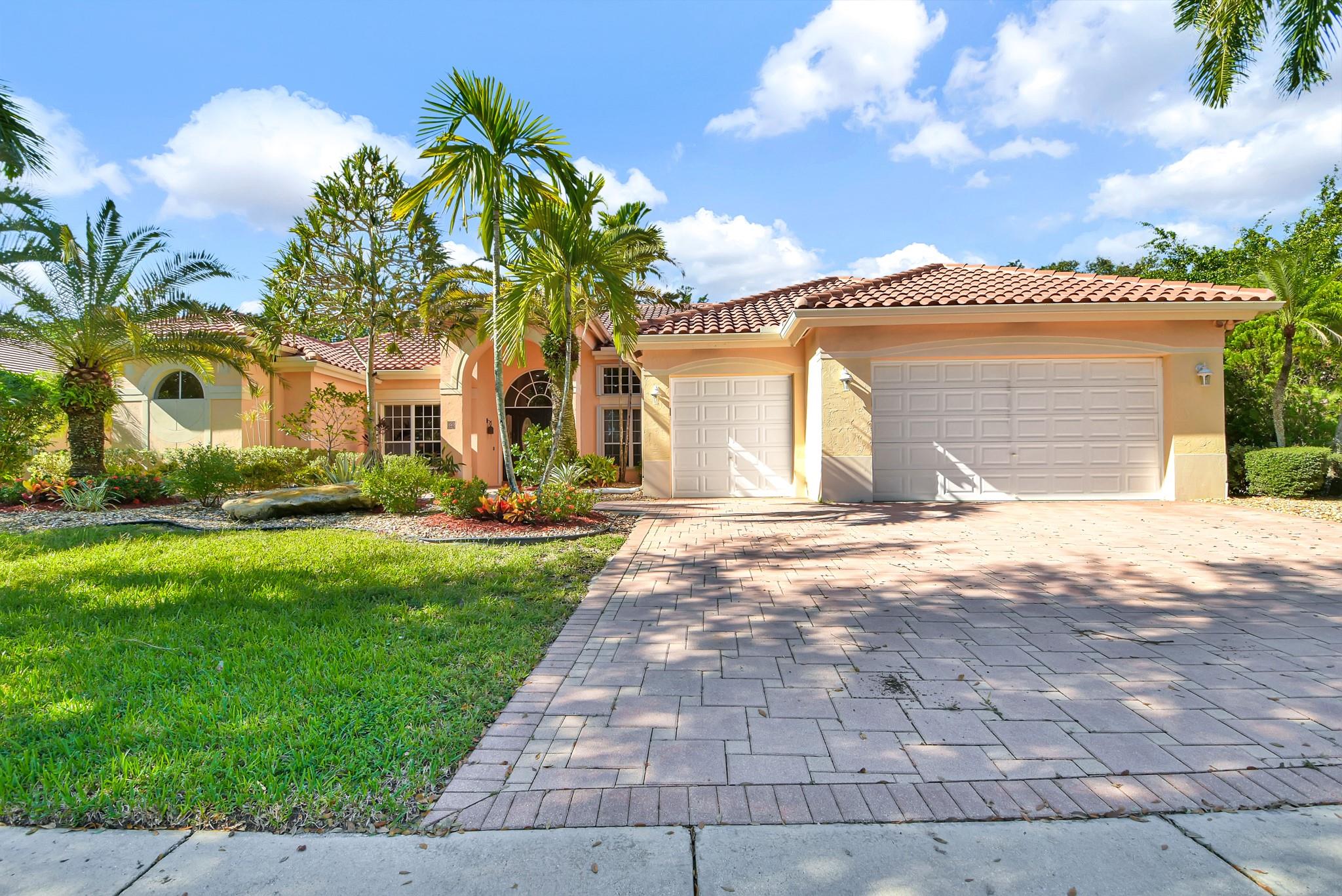 Precious home in the prestigious Weston Hills Country Club. 5 bedroom, 4,5 bath . Features an expansive 3,300 SF layout filled with natural light, soaring vaulted ceilings, and timeless finishes including hardwood floors and stylish vinyl accents. The oversized 15,175 SF lot is enhanced by serene pool with a tranquil water view and a spacious screened enclosure, perfect for enjoying outdoor lifestyle year -round. Roof replaced in 2016. Ready to move in and make it yours!
